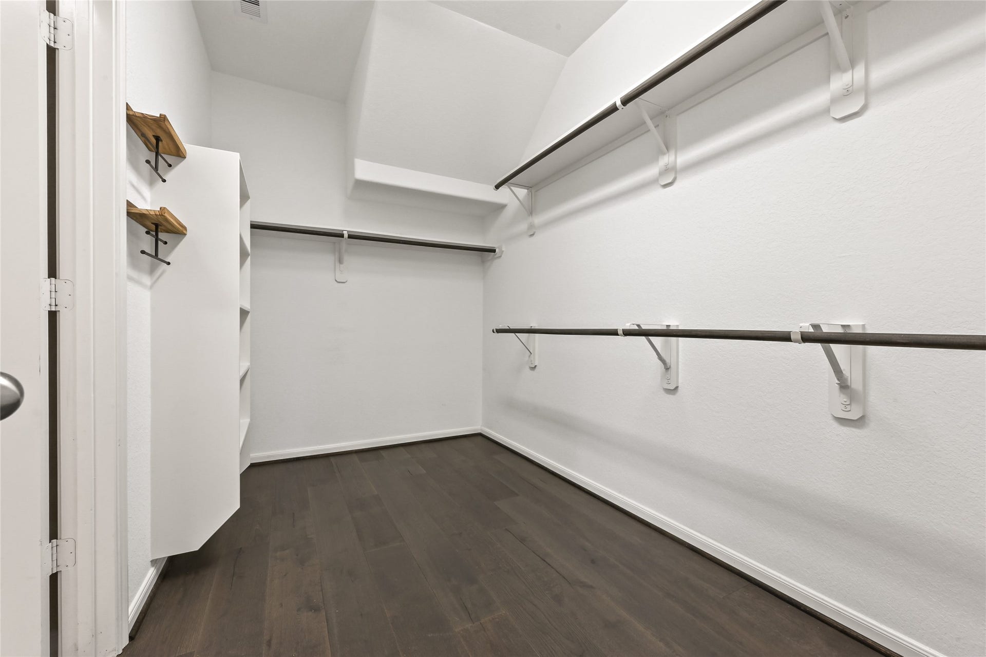 Oversized walk-in closet with built-in shelving and storage.