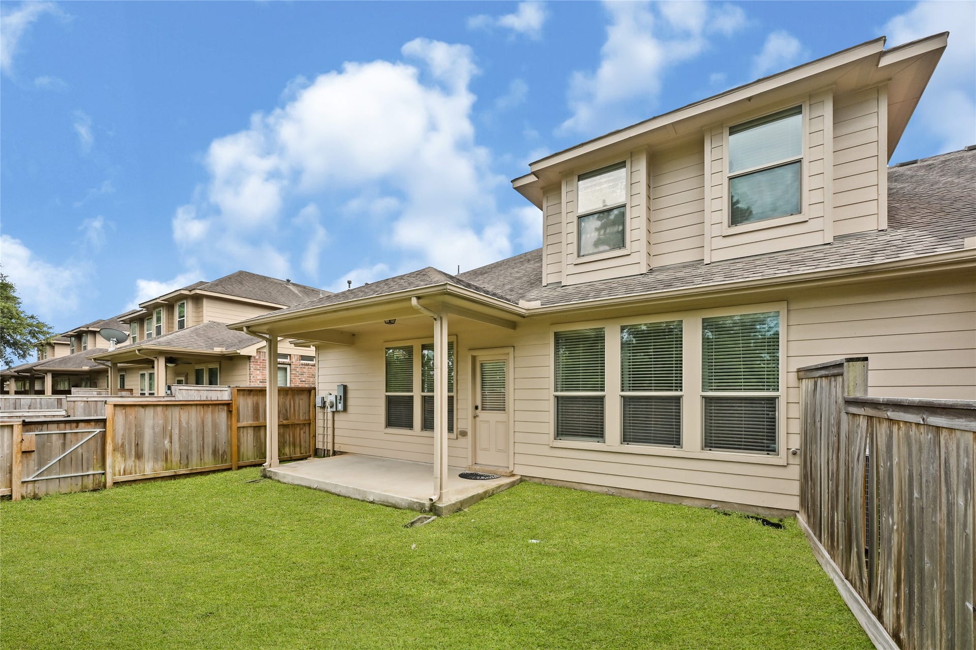 Covered patio and private backyard provide the perfect outdoor retreat.