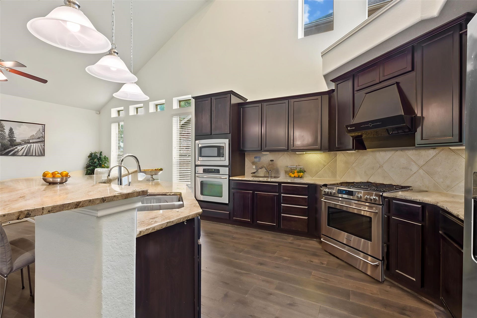 Spacious kitchen featuring granite countertops, breakfast bar, and ample cabinetry.