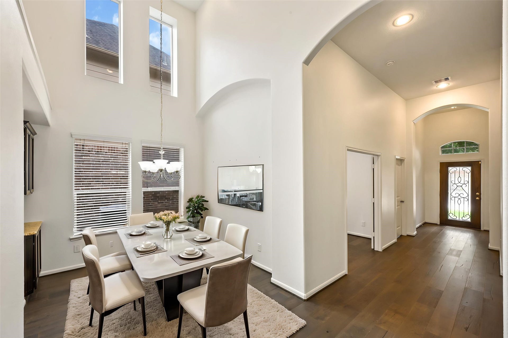 Elegant entry foyer showcasing high ceilings and architectural archways.