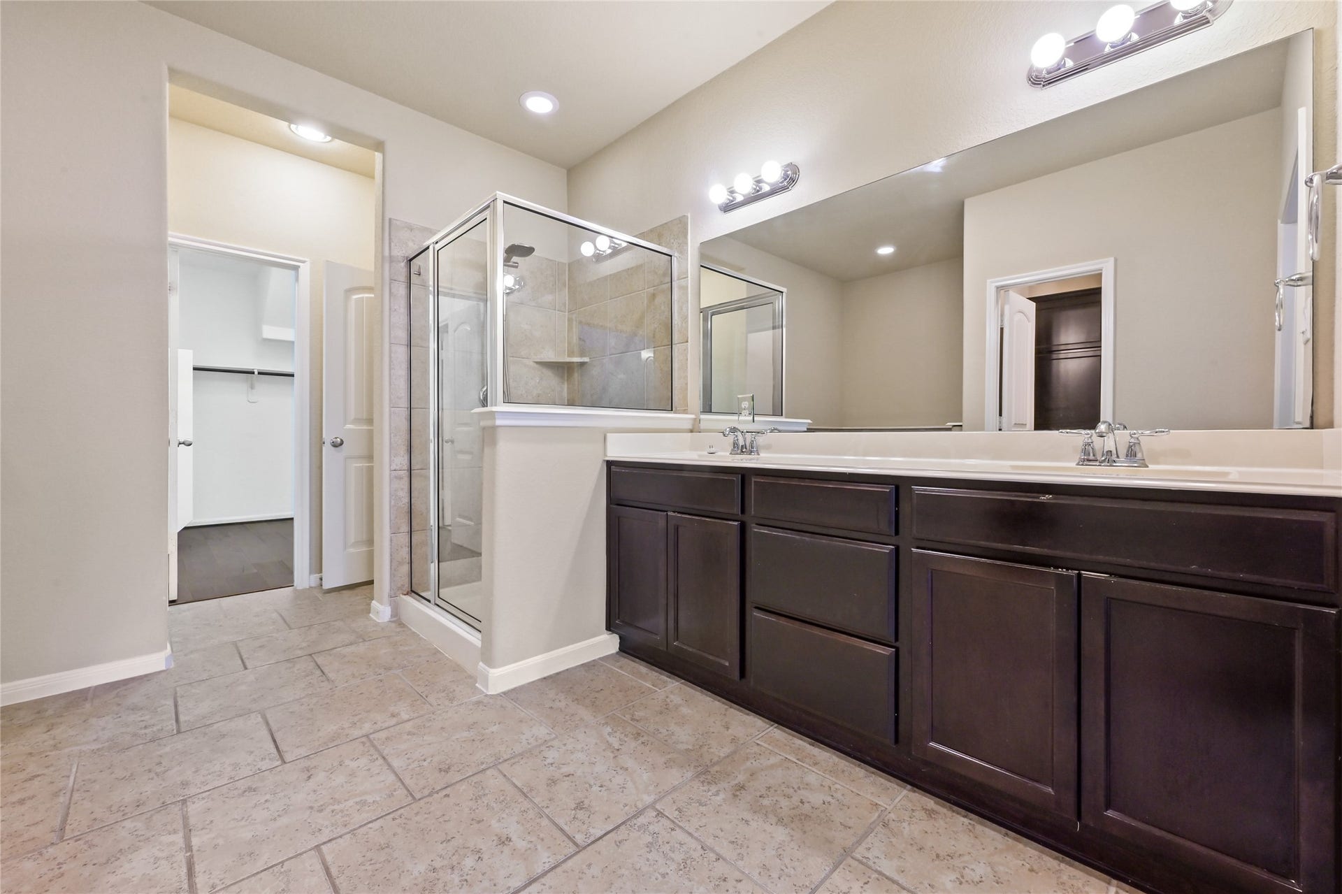 Primary bath featuring dual vanities and abundant storage space.
