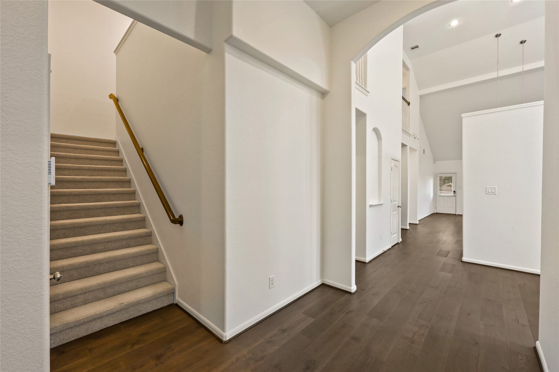 Welcoming foyer with staircase and easy access to first-floor living spaces.