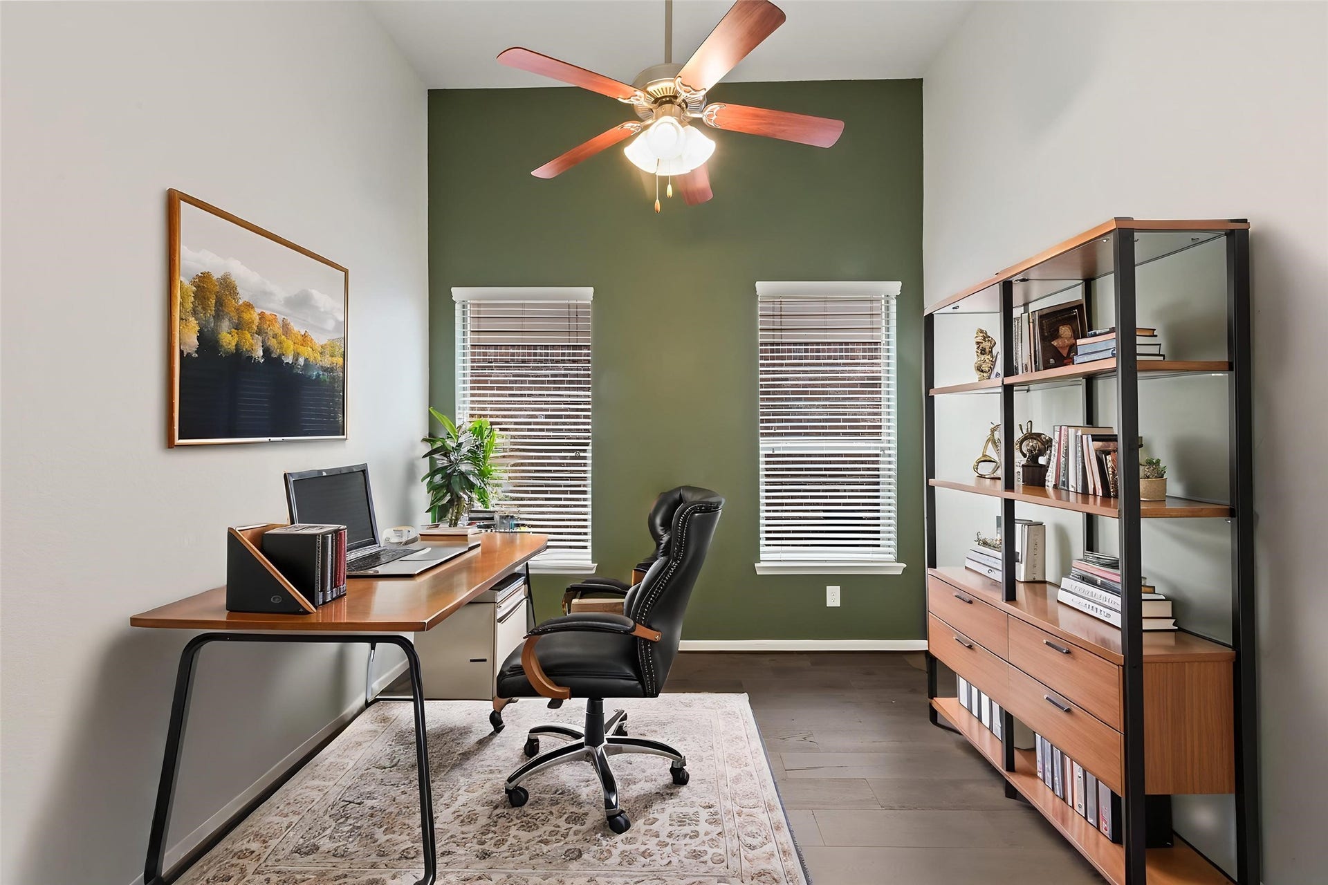 Private home office or study with ceiling fan and abundant natural light.