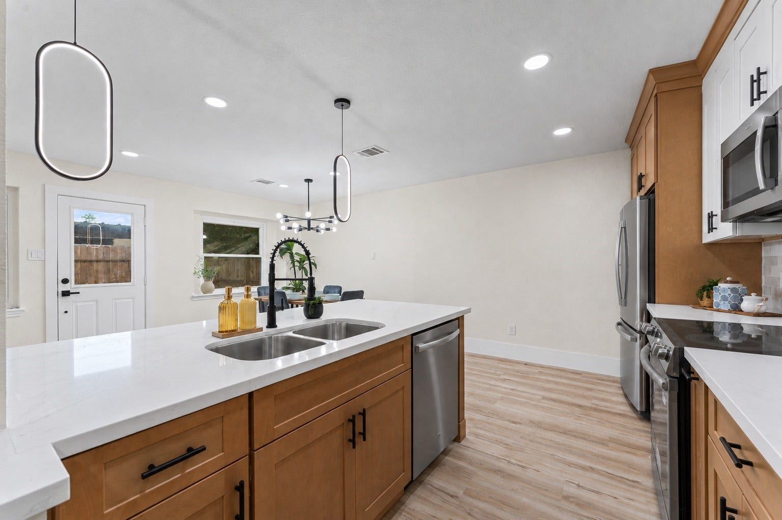 The kitchen has all new appliances, new light fixtures, new cabinets, and new quartz countertops.