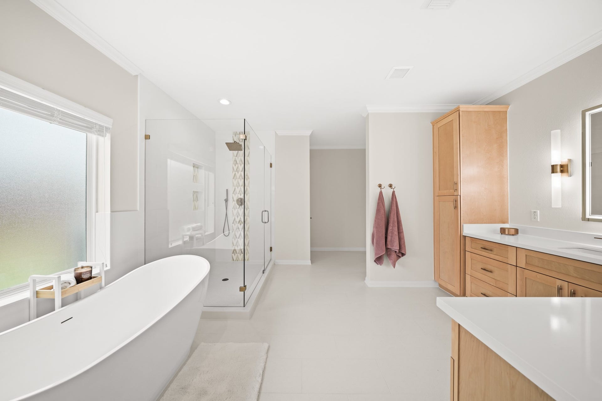 403 Trail Head Street, Friendswood, TX 77546 Resort-style primary bath featuring a freestanding soaking tub, designer tile accents, and a spacious frameless glass shower.