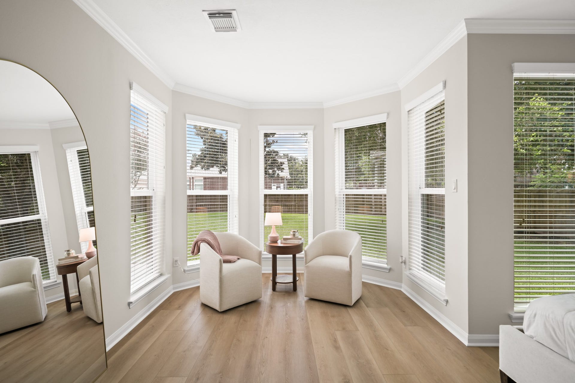 403 Trail Head Street, Friendswood, TX 77546 Wrapped in windows and bathed in natural light, this elegant sitting area transforms the primary suite into a true sanctuary for relaxation and reflection.