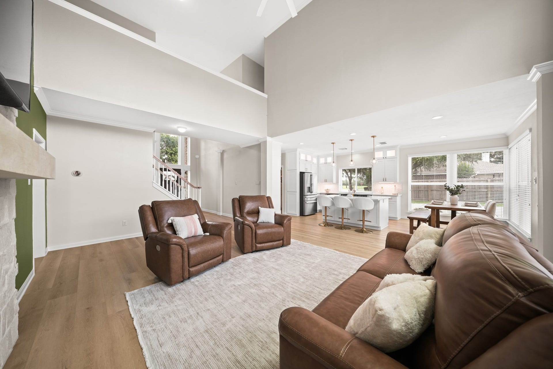 403 Trail Head Street, Friendswood, TX 77546 A view from the living room captures the home's airy layout, grand foyer, and thoughtfully designed interiors that blend elegance with everyday comfort.