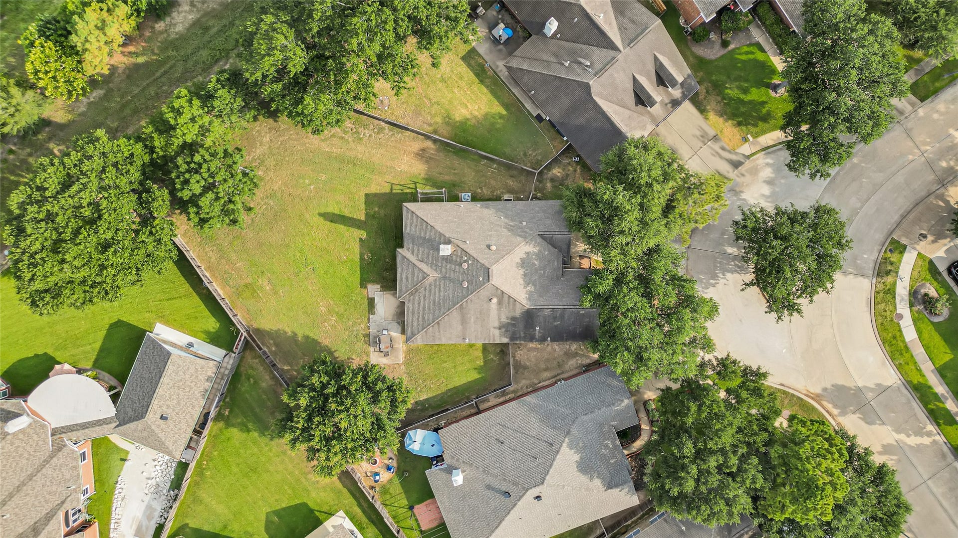 7102 Hollow Field Lane, Cypress, TX 77433 Spectacular aerial view highlighting the home's sprawling lot size, massive fully fenced backyard, surrounding mature trees, and prime neighborhood footprint.
