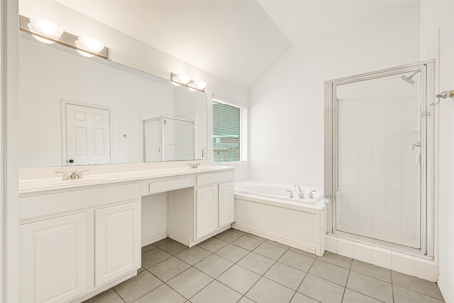 7102 Hollow Field Lane, Cypress, TX 77433 Luxurious primary bath featuring an oversized double-sink vanity with a built-in makeup station, a deep soaking tub, and a separate glass-enclosed