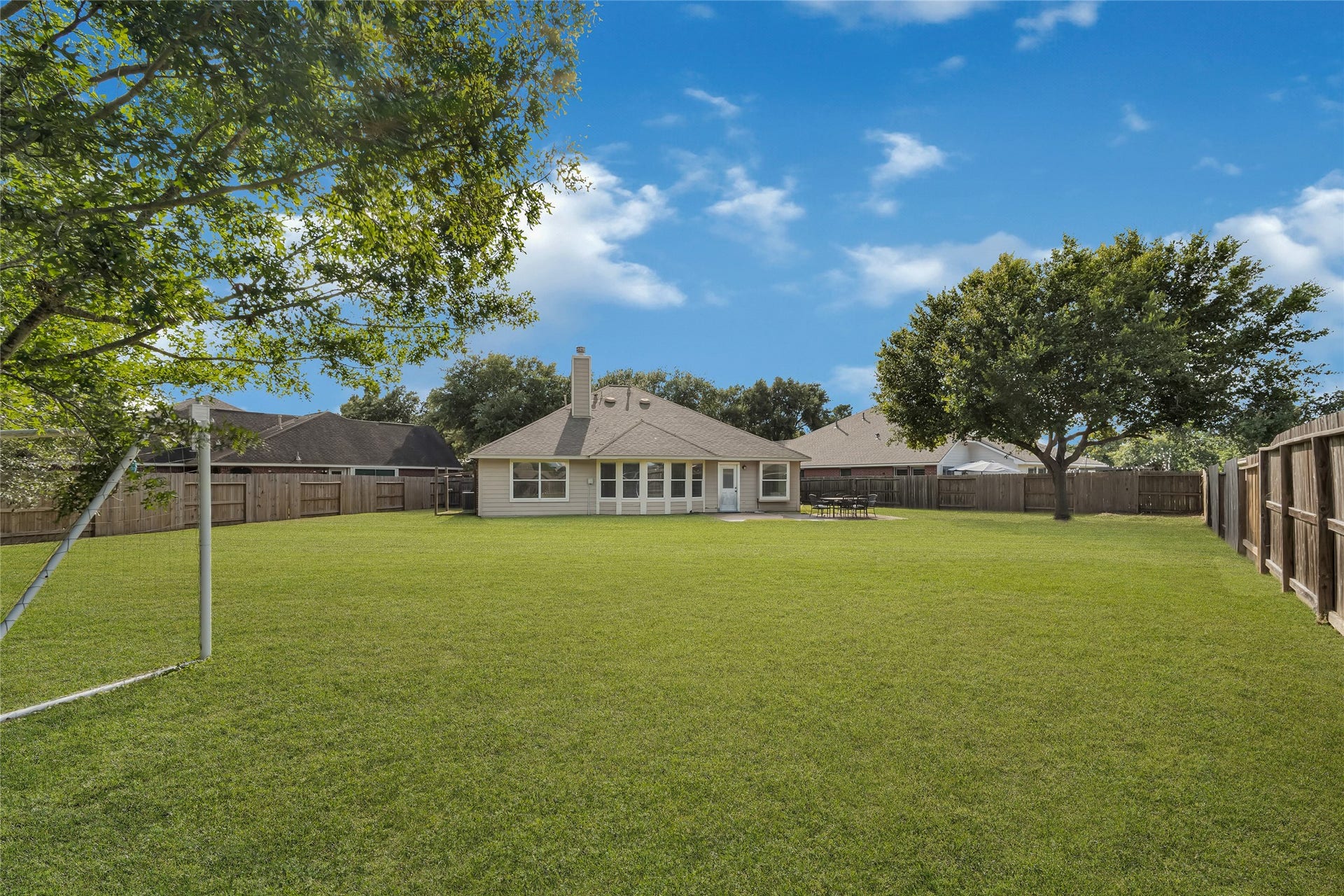 7102 Hollow Field Lane, Cypress, TX 77433 Incredible view of the massive, fully fenced backyard offering tons of lush green space for play, pets, or future outdoor additions.