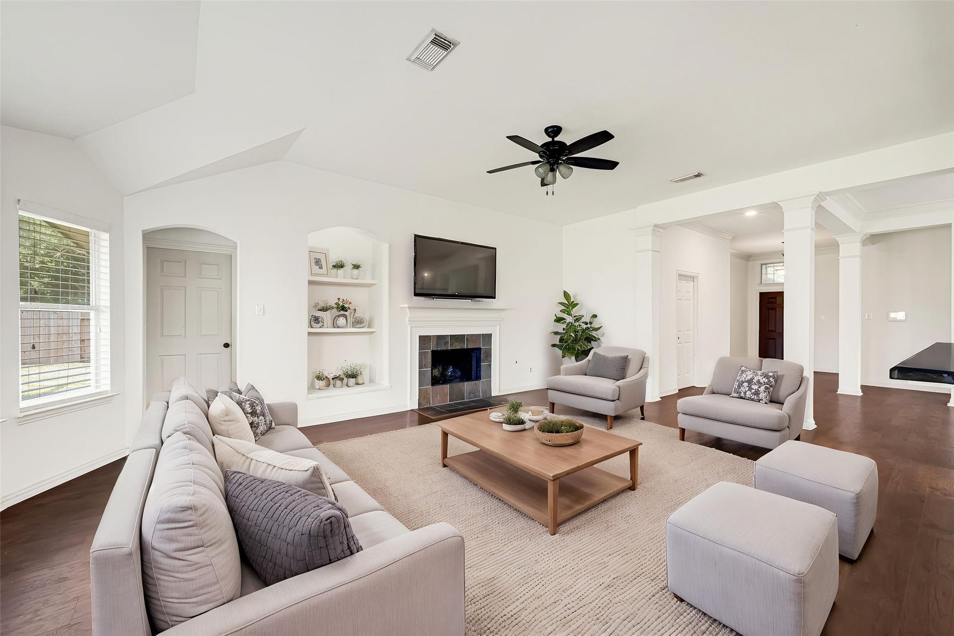 7102 Hollow Field Lane, Cypress, TX 77433 Virtually Staged: Alternative angle of the living room emphasizing its impressive size, tall ceilings, classic crown molding, and seamless sightlines across the main level.