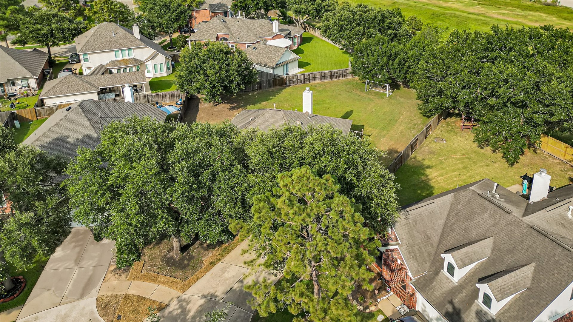 7102 Hollow Field Lane, Cypress, TX 77433 Spectacular aerial view highlighting the home's sprawling lot size, massive fully fenced backyard, surrounding mature trees, and prime neighborhood footprint.