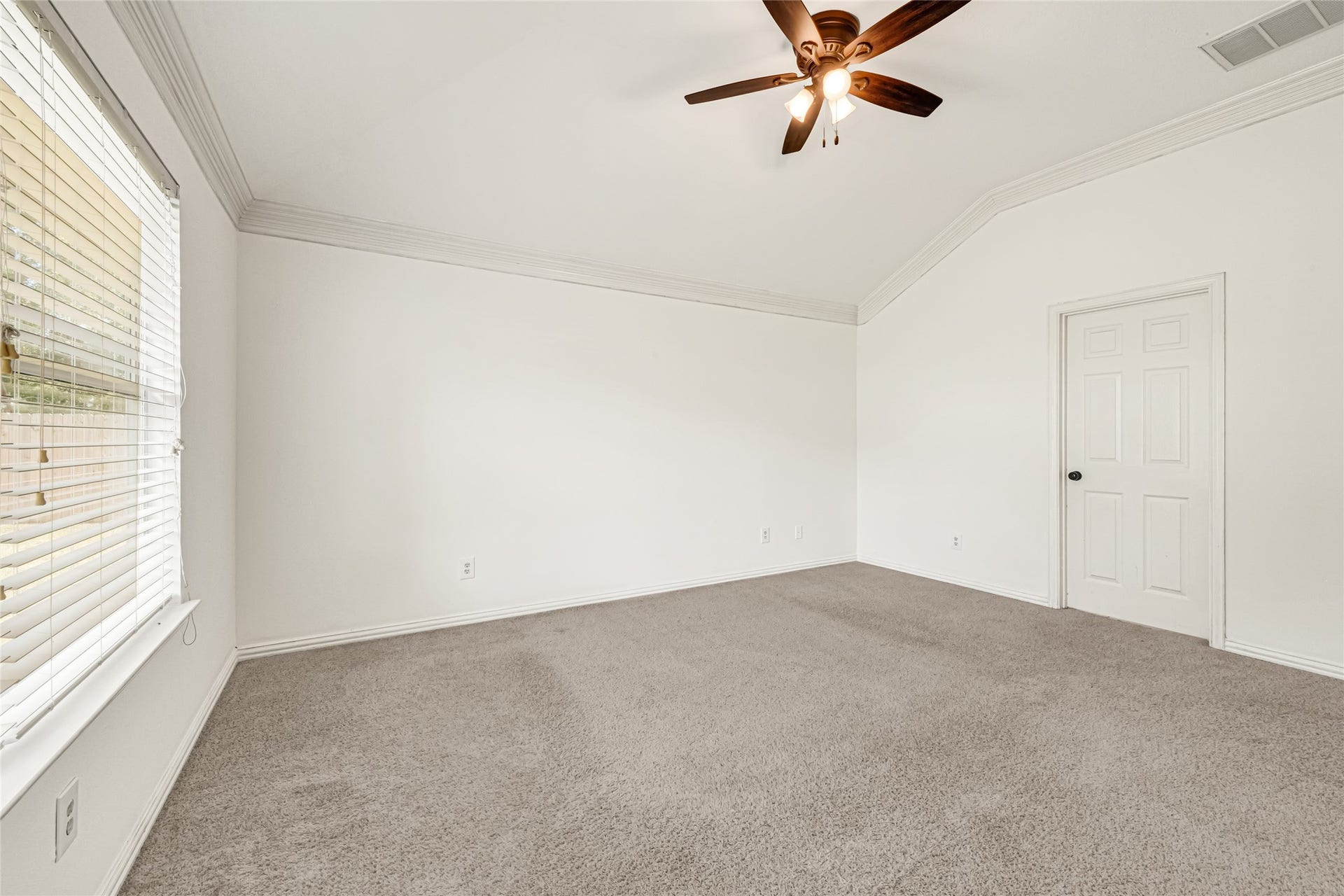 7102 Hollow Field Lane, Cypress, TX 77433 Virtually Staged: Another view of the expansive primary bedroom, highlighting the flexible floor plan and a large window looking out toward the private backyard.