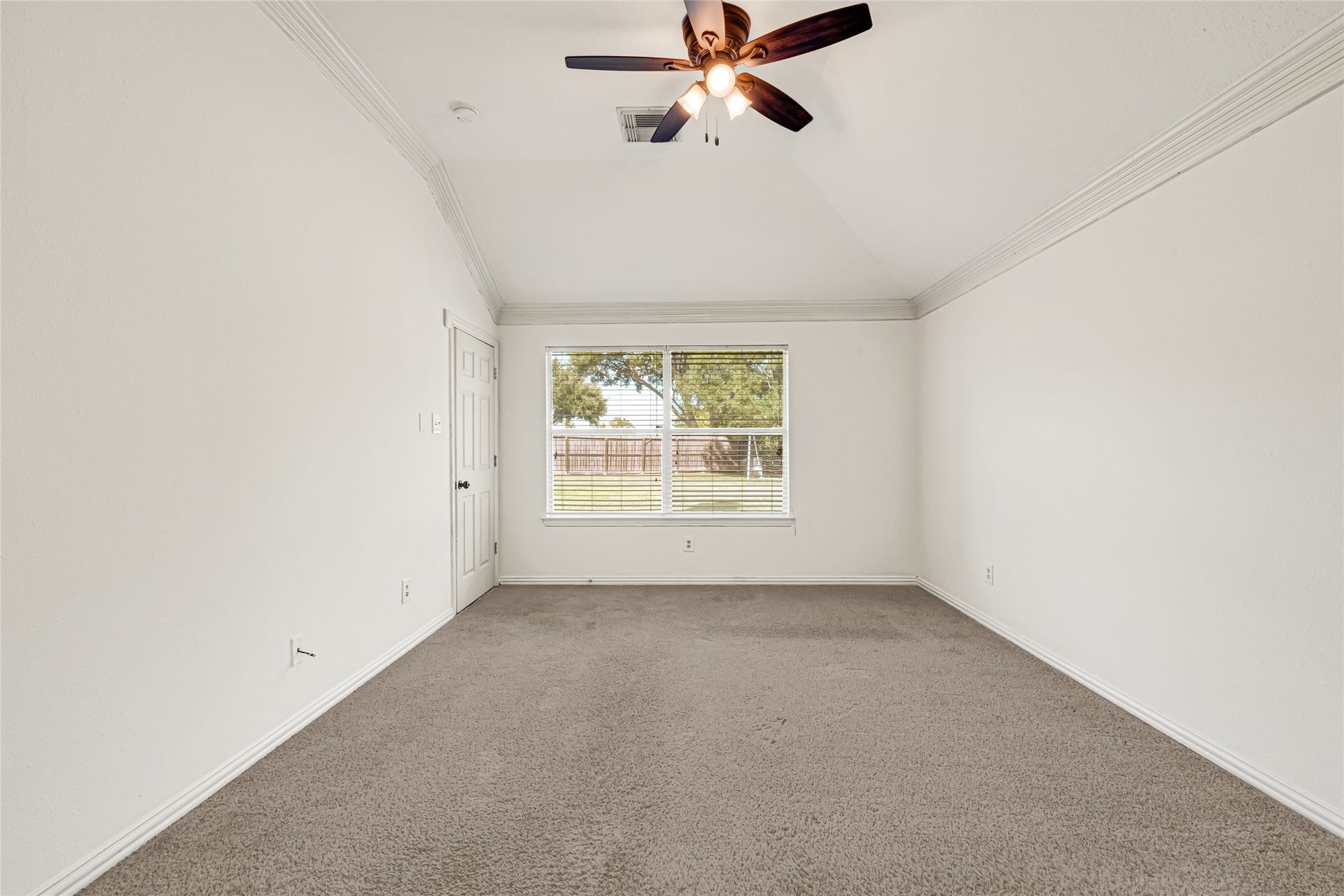 7102 Hollow Field Lane, Cypress, TX 77433 Another view of the expansive primary bedroom, highlighting the flexible floor plan and a large window looking out toward the private backyard.