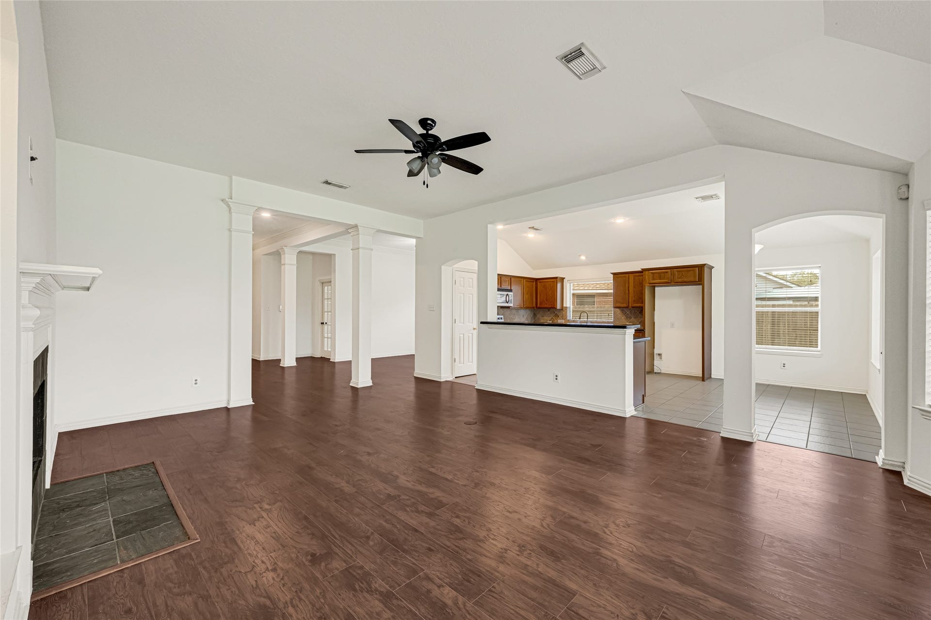 7102 Hollow Field Lane, Cypress, TX 77433 A great room view looking back toward the kitchen and entry foyer, highlighting the open-concept layout and versatile flow between everyday living spaces.