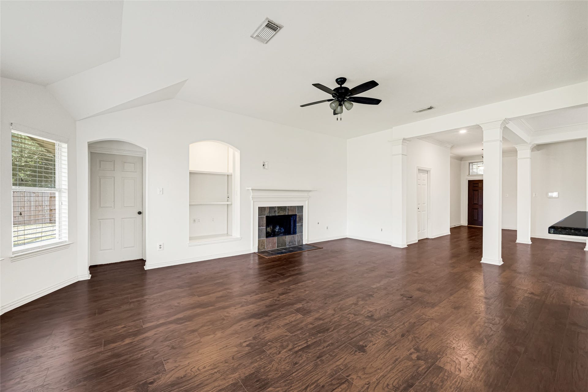 7102 Hollow Field Lane, Cypress, TX 77433 Alternative angle of the living room emphasizing its impressive size, tall ceilings, classic crown molding, and seamless sightlines across the main level.