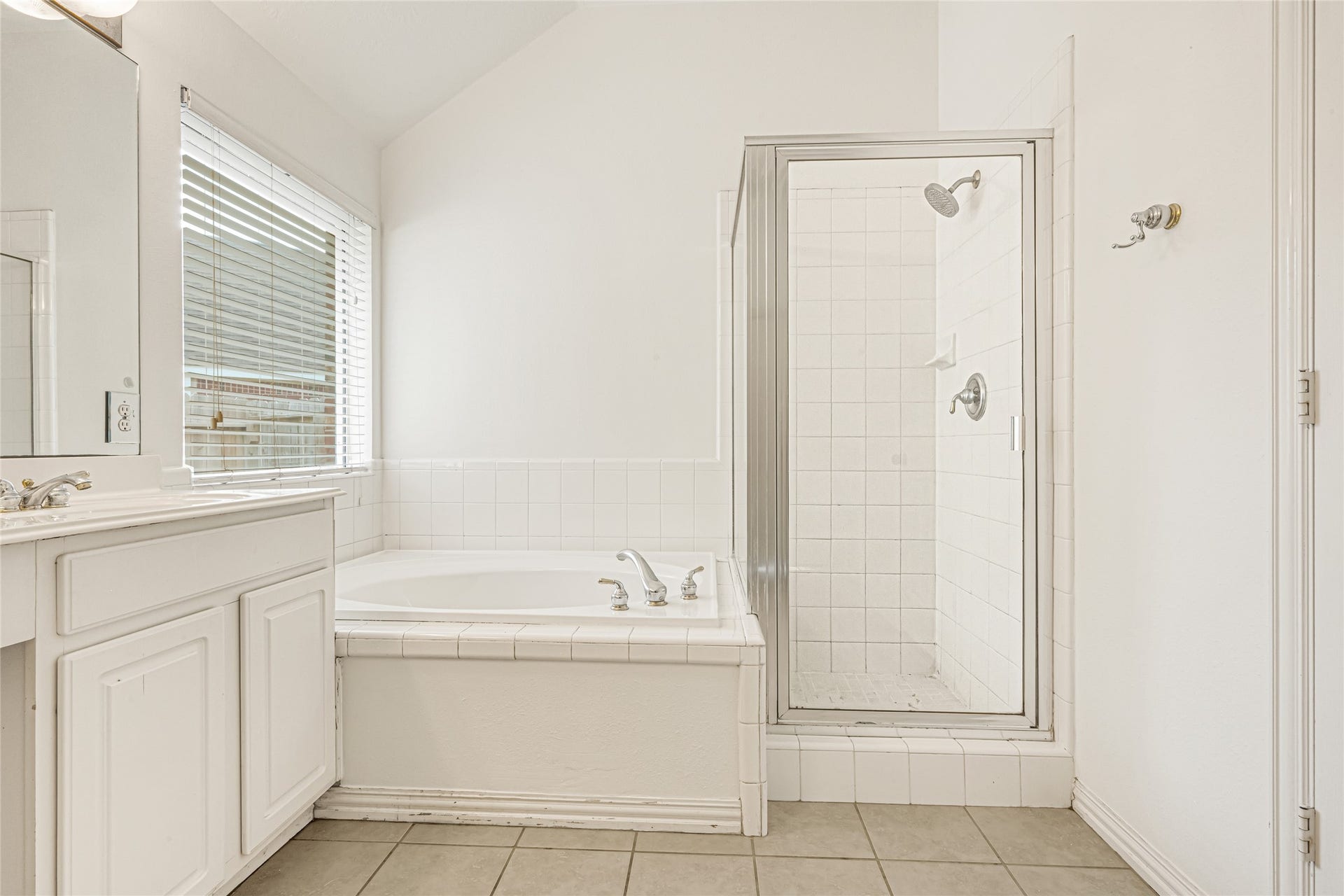 7102 Hollow Field Lane, Cypress, TX 77433 A closer look at the primary bathroom's layout, emphasizing the dedicated soaking tub and separate walk-in tiled shower.