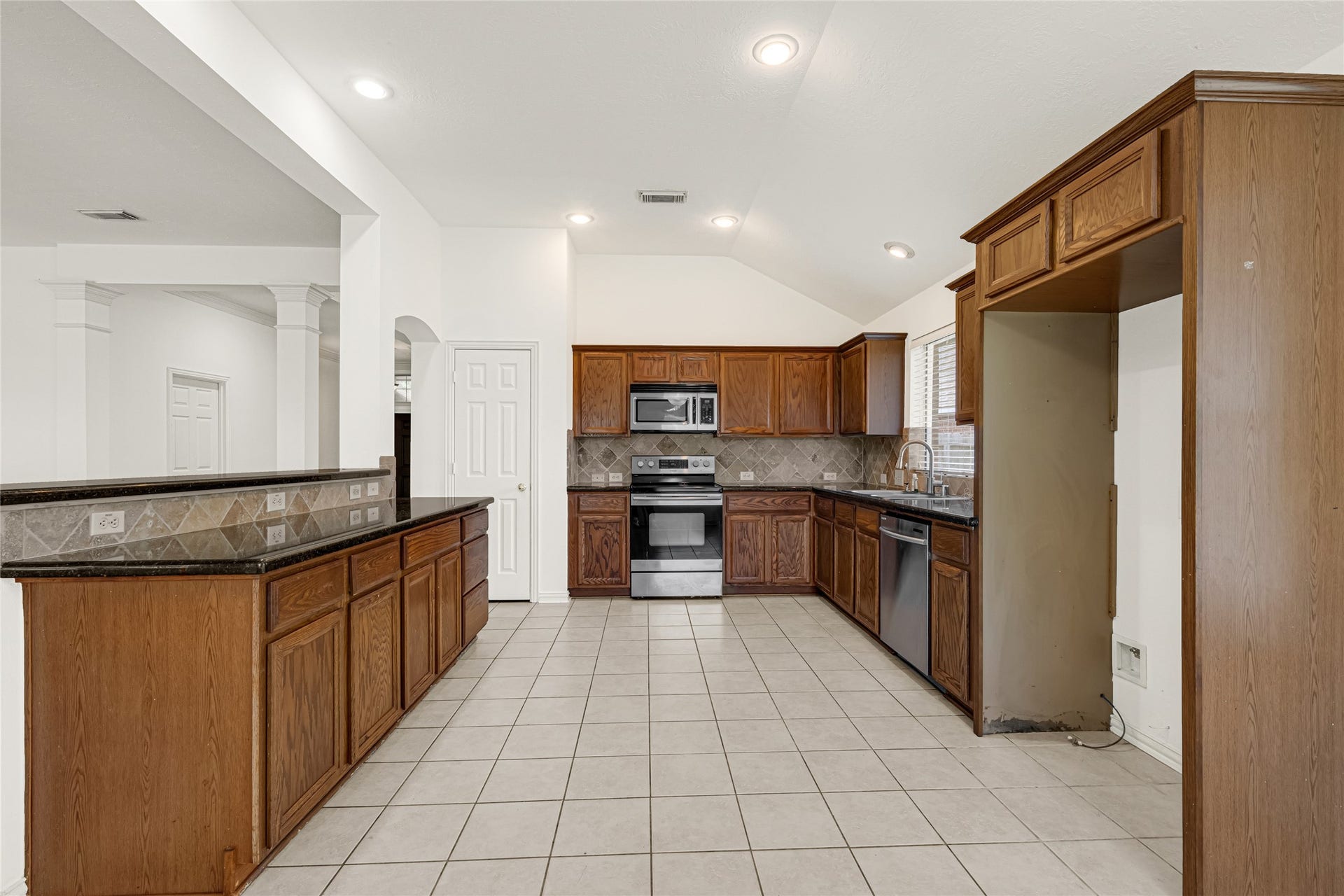 7102 Hollow Field Lane, Cypress, TX 77433 Wide-angle view of the kitchen showing the full wrap-around layout, optimal workspace triangle, and convenient proximity to the breakfast room.