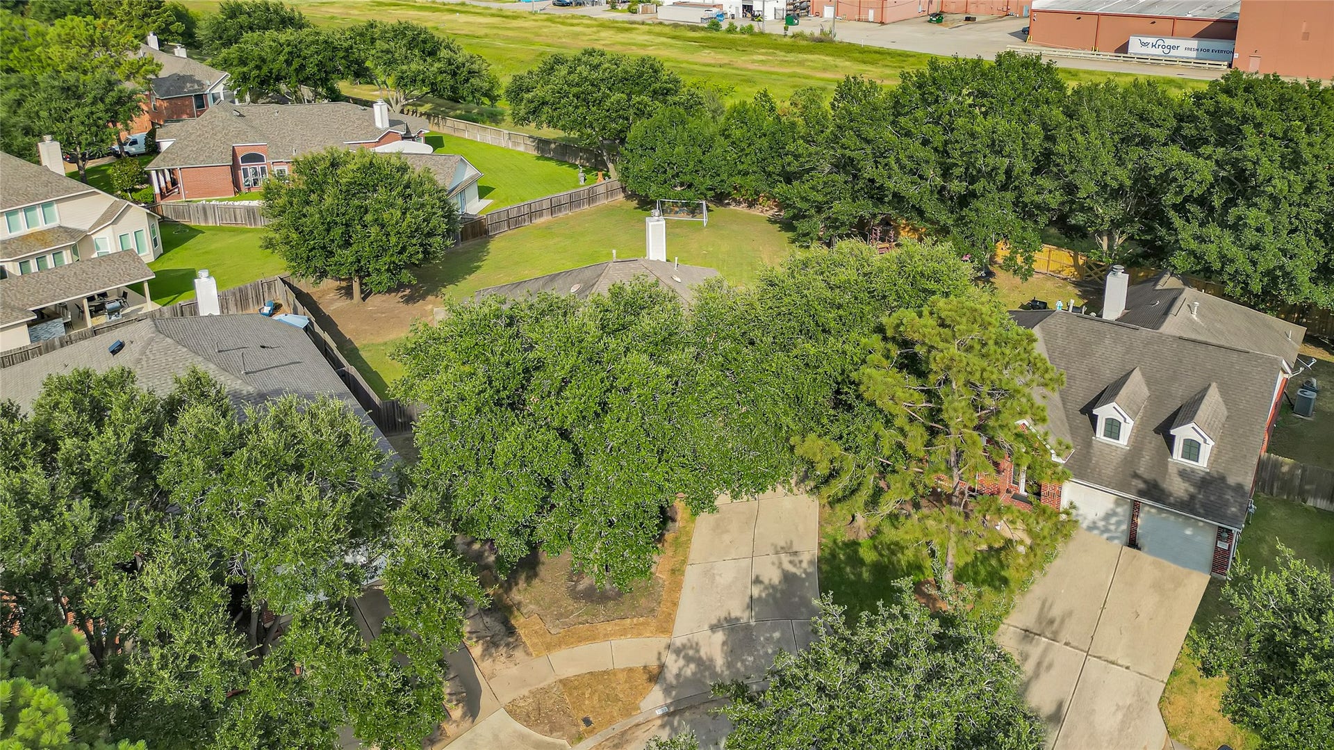 7102 Hollow Field Lane, Cypress, TX 77433 Spectacular aerial view highlighting the home's sprawling lot size, massive fully fenced backyard, surrounding mature trees, and prime neighborhood footprint.