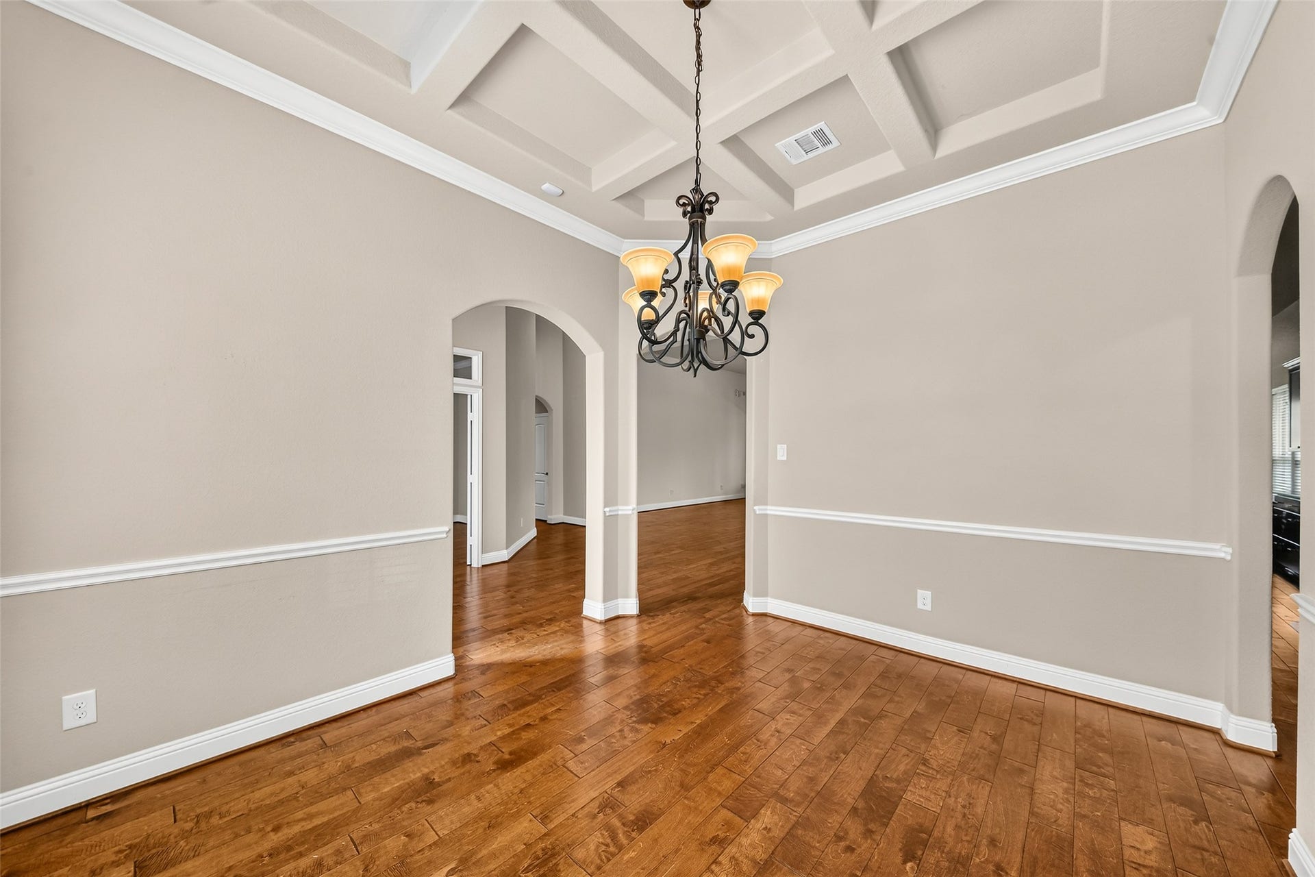 12218 Rampy Green Drive, Tomball, TX 77377 As you enter you are greeted with an elegant dining room featuring a coffered ceiling, and rich hardwood floors, creating a warm and inviting atmosphere.