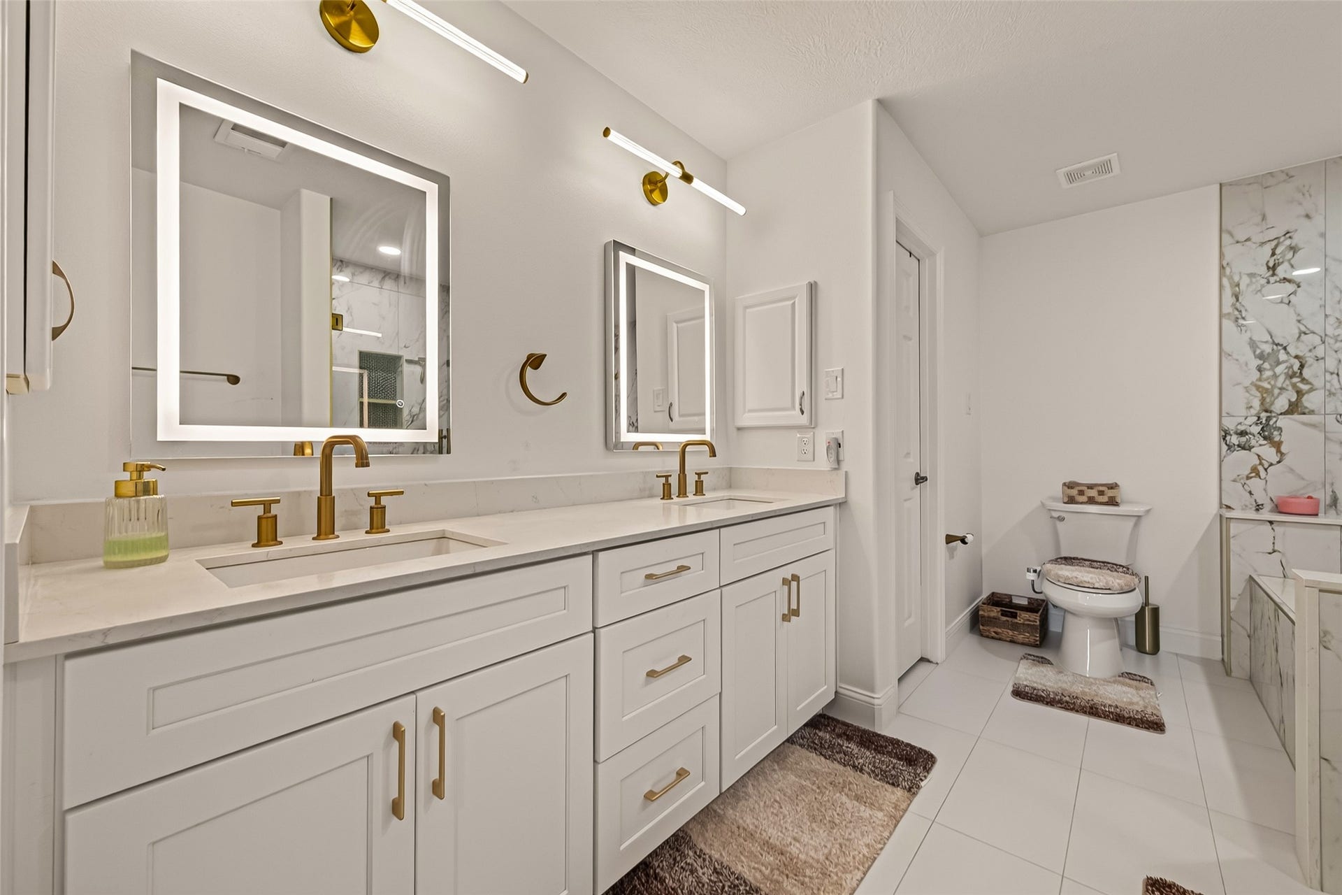2865 Westhollow Drive, #43, Houston, TX 77082 Spa-inspired primary ensuite featuring dual vanities, backlit mirrors, and luxurious marble finishes.
