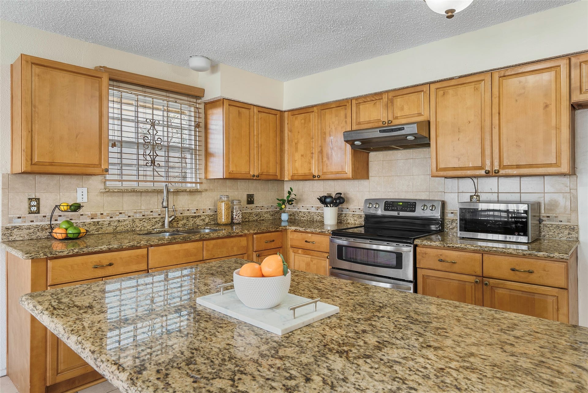 This enormous kitchen will delight the chef of the home! Enjoy plenty of counter and storage space, with stainless steel appliances!