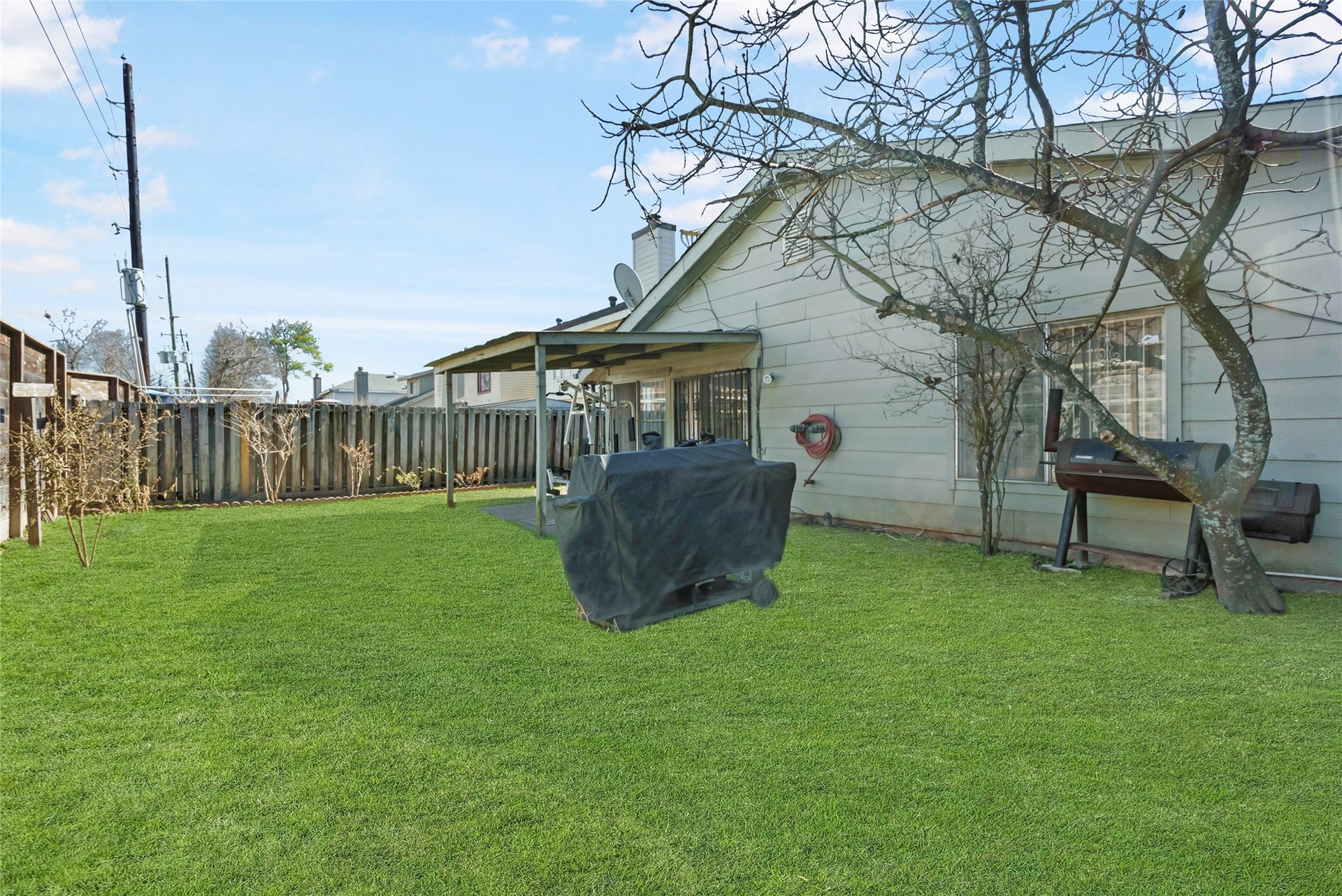 This easy to maintain yard is the perfect setting for backyard barbecues and fun with family and friends!