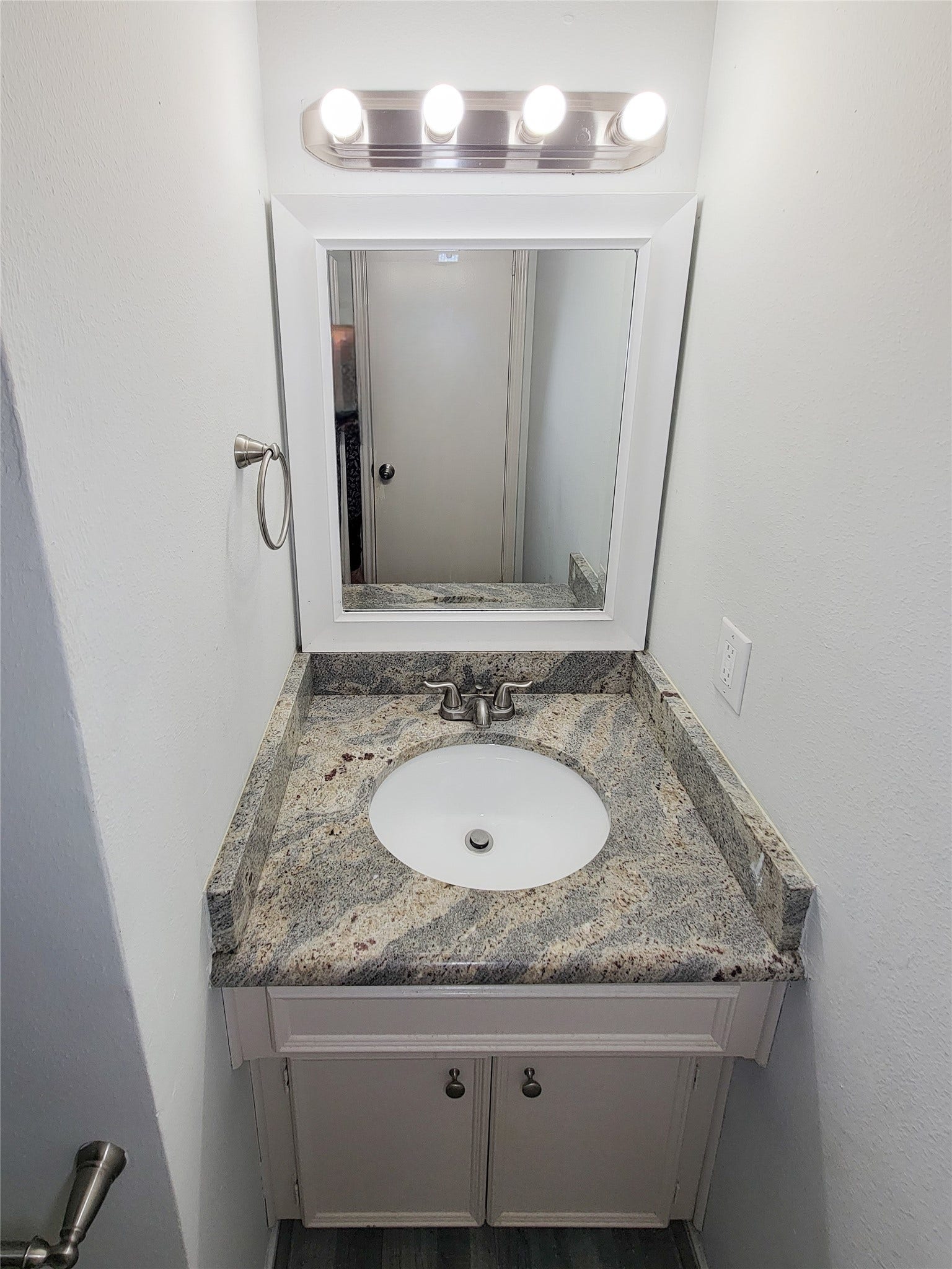 80 Fallenstone Drive, The Woodlands, TX 77381 Charming bathroom with a sleek granite countertop vanity, modern faucet, and bright lighting, creating a clean and inviting space.