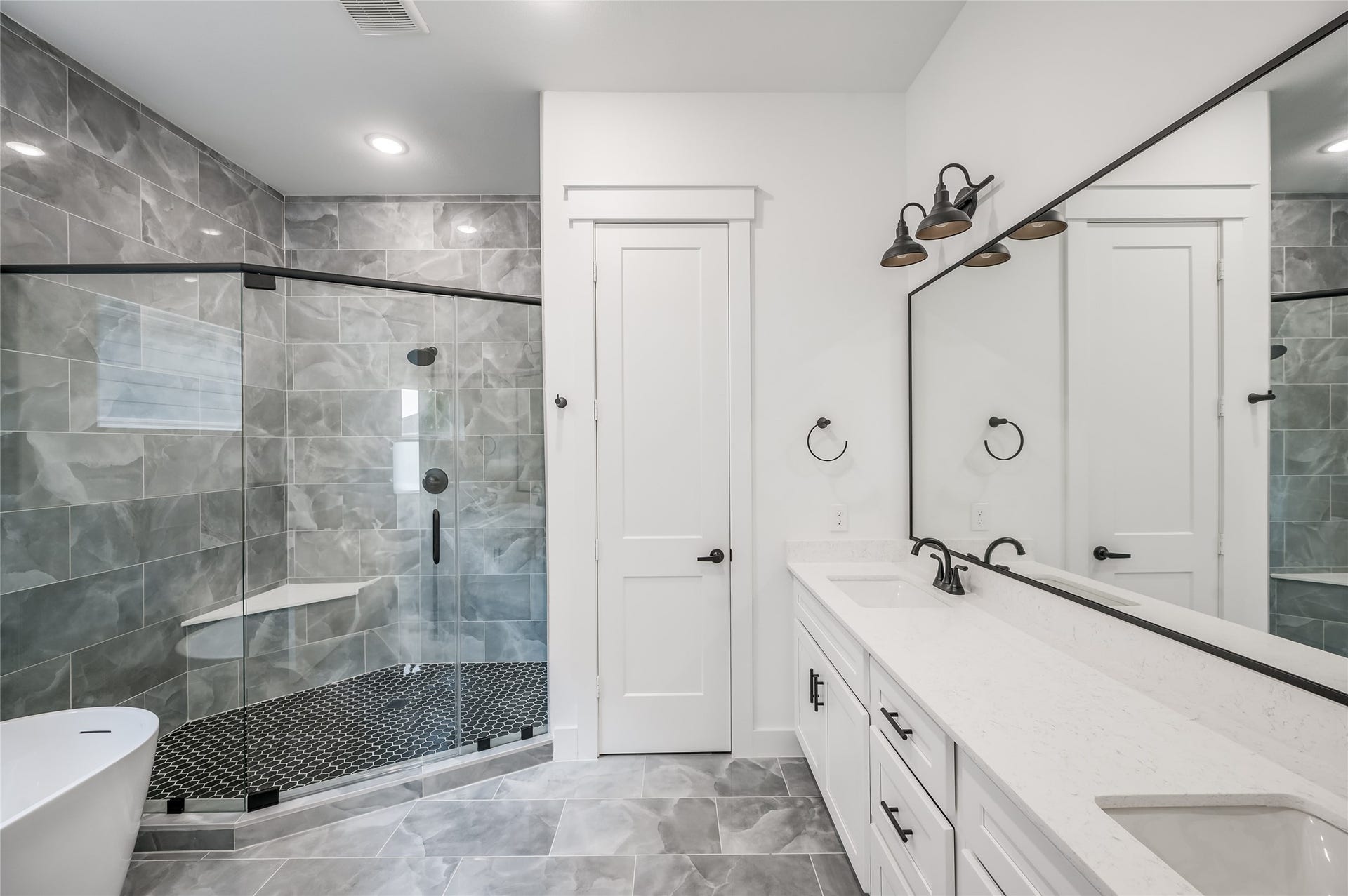 4605 Terry Street, Houston, TX 77009 The primary bath feels like a private spa, with a walk in shower and double vanity for easy mornings