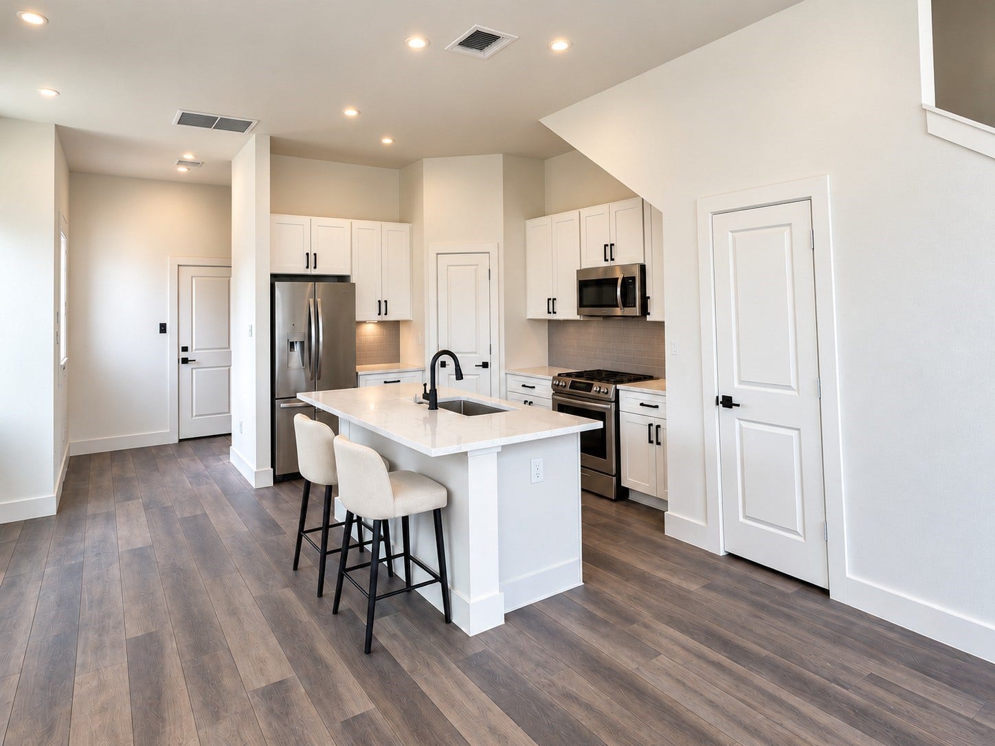 6029 Beall Street, Houston, TX 77091 Step into this bright, modern kitchen showcasing a beautiful combination of style, comfort, and functionality. Crisp white shaker-style cabinets, elegant stone-look countertops, and a coordinating tile backsplash create a timeless aesthetic. Stainless steel appliances and matte black fixtures add contemporary sophistication. The spacious center island features an undermount sink and comfortable seating for casual meals or conversation. These photos have been virtually rendered for visual reference.