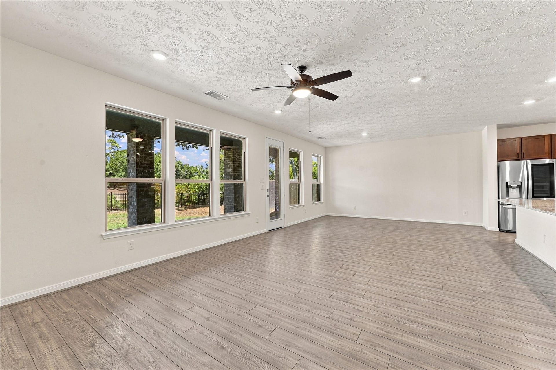 Open concept living with a wall of wondows overlooking the gorgeous scenery in back!
