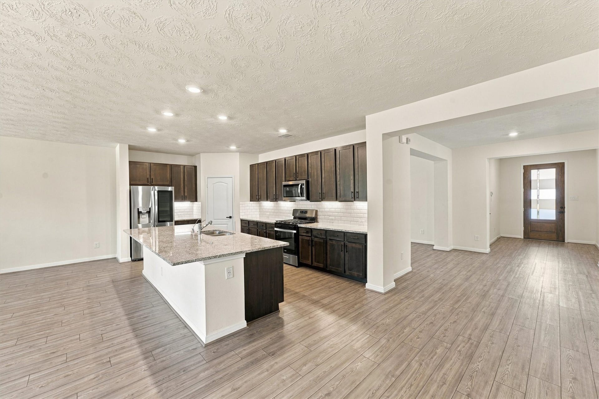 The entry leads directly to the open kitchen/living area.