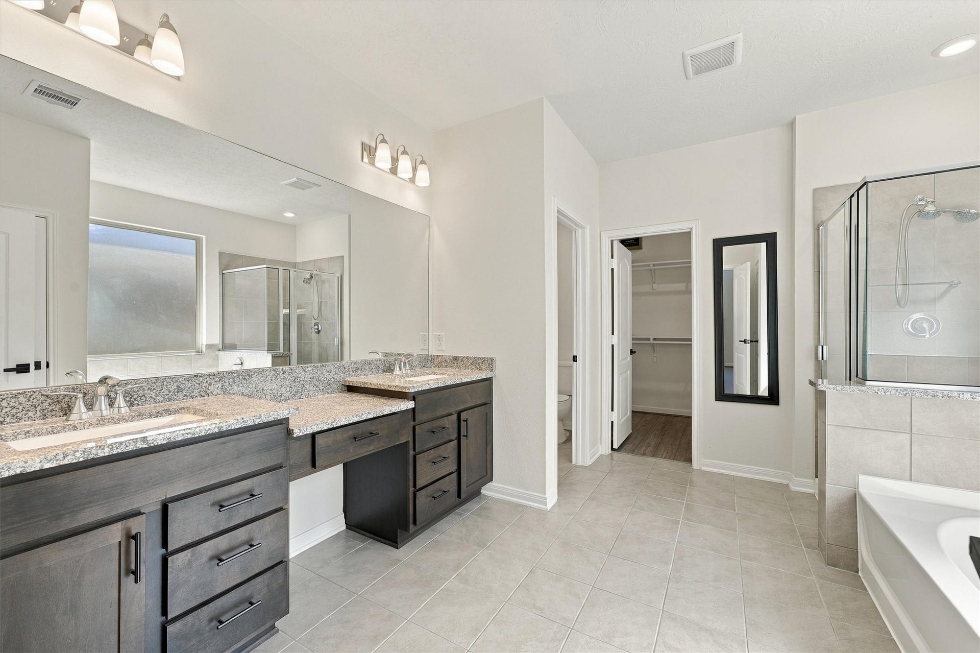 Primary bath with dual sinks and a vanity area