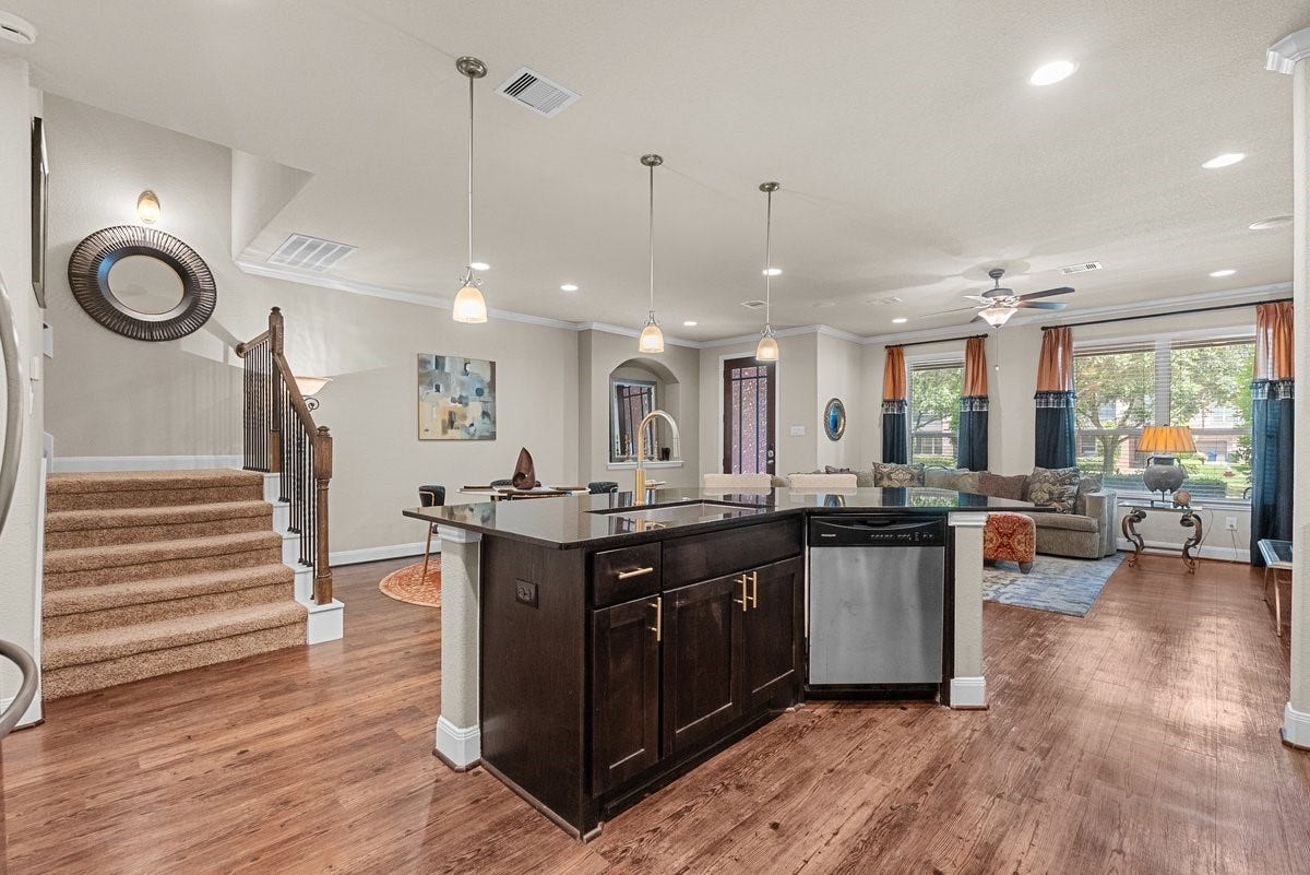 416 Via Regatta Drive, Webster, TX 77598 The open island kitchen seamlessly transitions to a large living area.