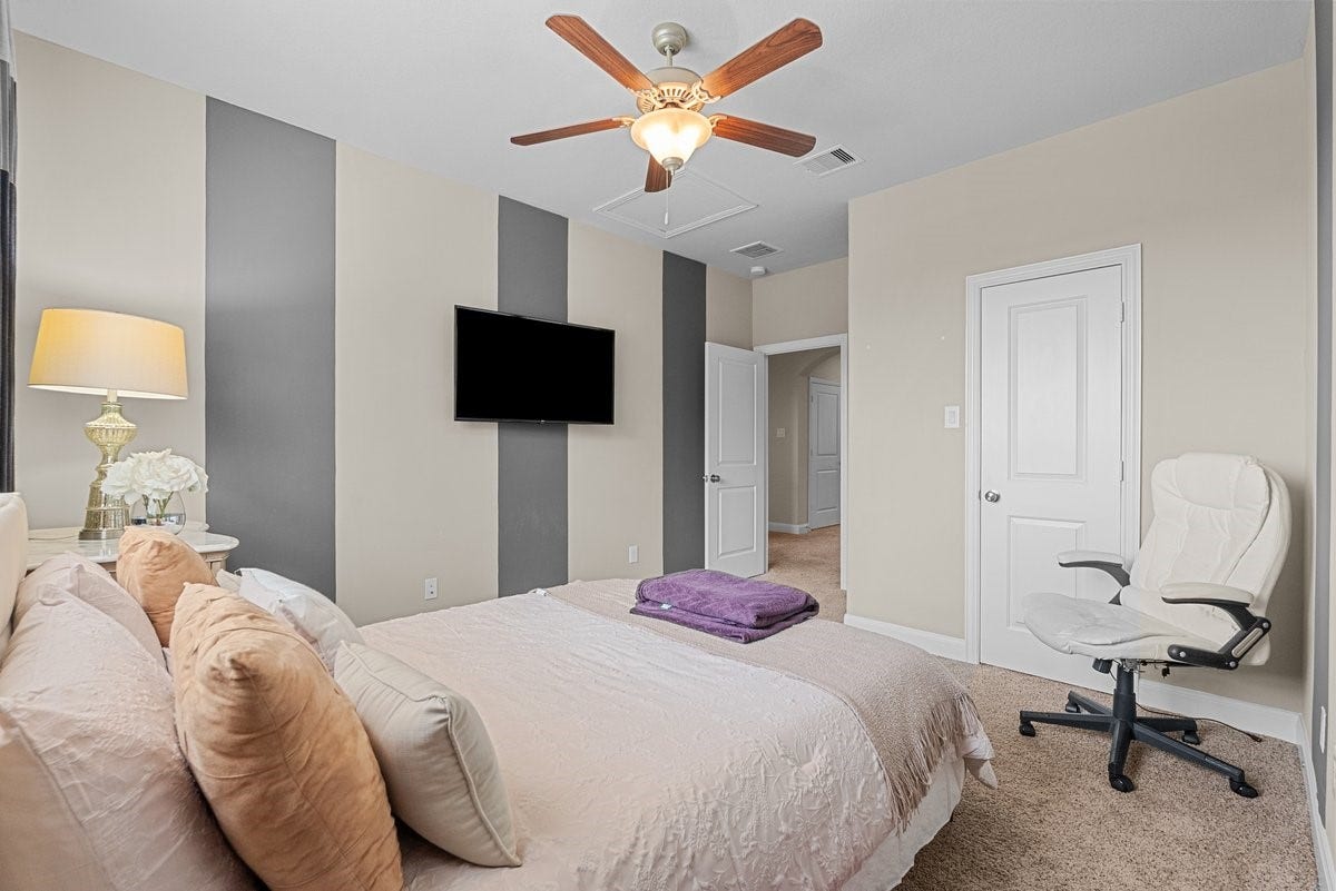 416 Via Regatta Drive, Webster, TX 77598 The third bedroom, also located on the second floor, continues the homes theme of bespoke luxury with custom-painted vertical stripes. This striking feature wall adds incredible depth and a contemporary edge to the room.