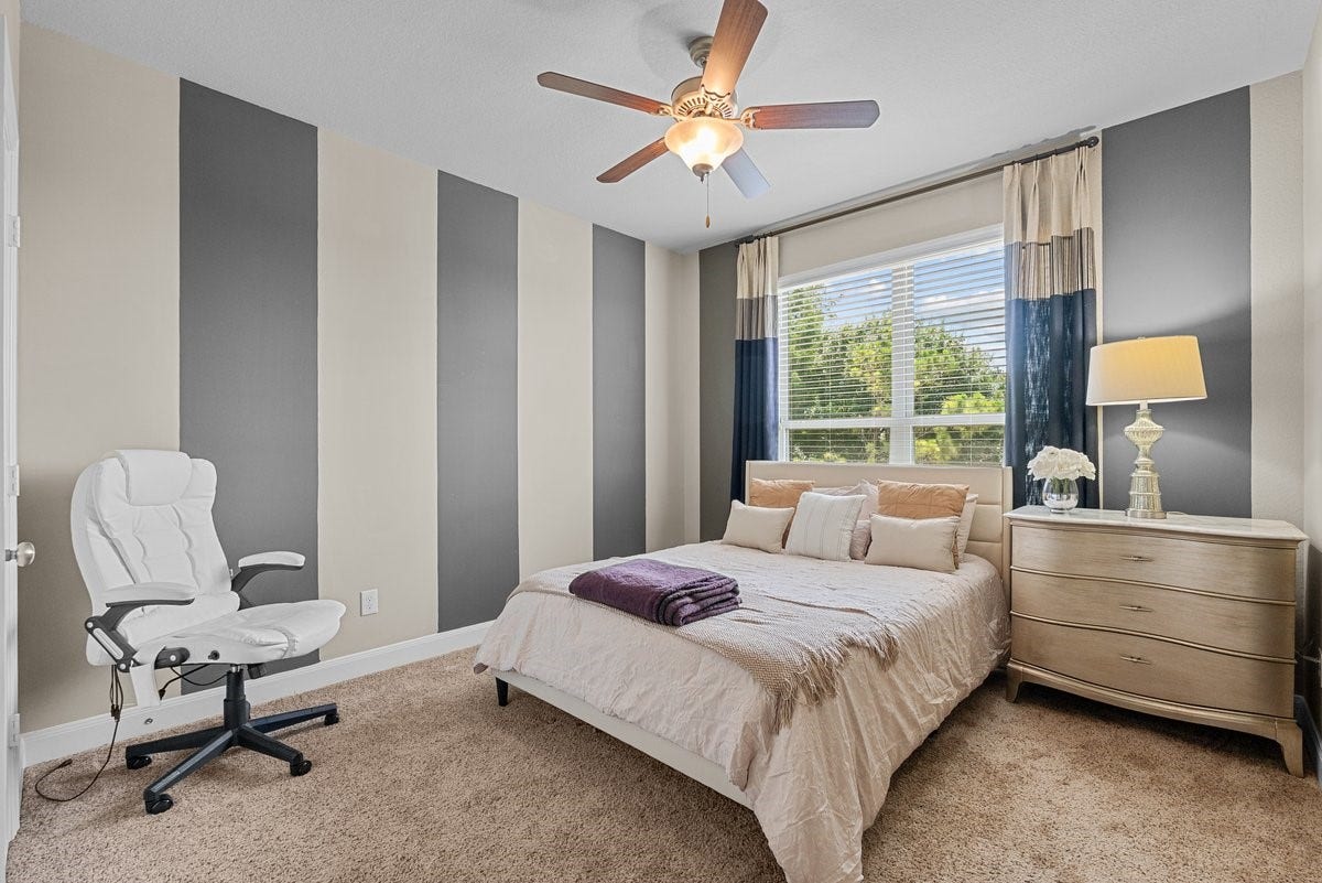 416 Via Regatta Drive, Webster, TX 77598 A large window floods the space with bright natural light, while a central ceiling fan keeps the area cool and comfortable.