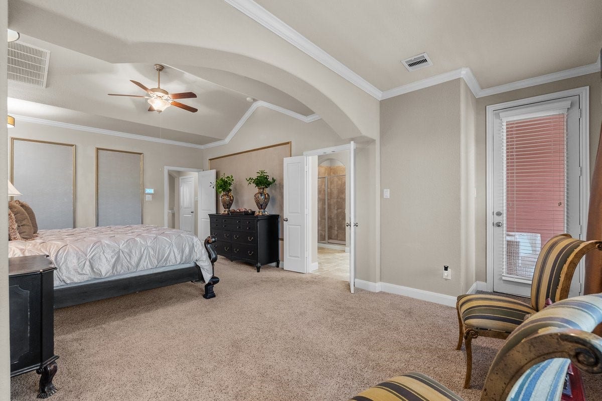 416 Via Regatta Drive, Webster, TX 77598 Dramatic vaulted tray ceilings add grand architectural volume, while the wide doorway offers a view extending into the bright, attached multi-room lounge. Every detail reflects true artisan craftsmanship!