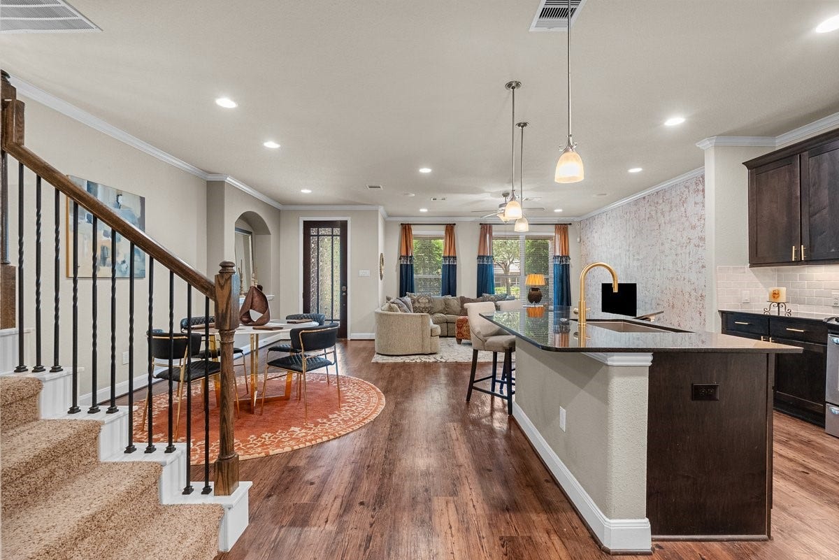 416 Via Regatta Drive, Webster, TX 77598 Positioned perfectly for daily living or large gatherings, this inviting space looks back onto the gourmet kitchen and beautiful wrought-iron staircase.
