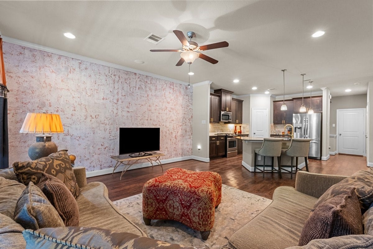416 Via Regatta Drive, Webster, TX 77598 This view from the entryway highlights the homes exceptional flow, showcasing the rich wood flooring that spans the entire level.