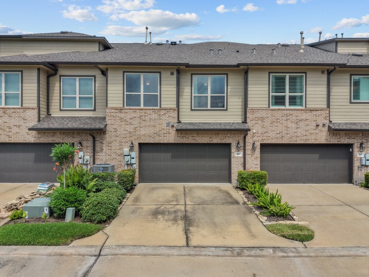 416 Via Regatta Drive, Webster, TX 77598 Rear view of property and spacious 2 car garage.