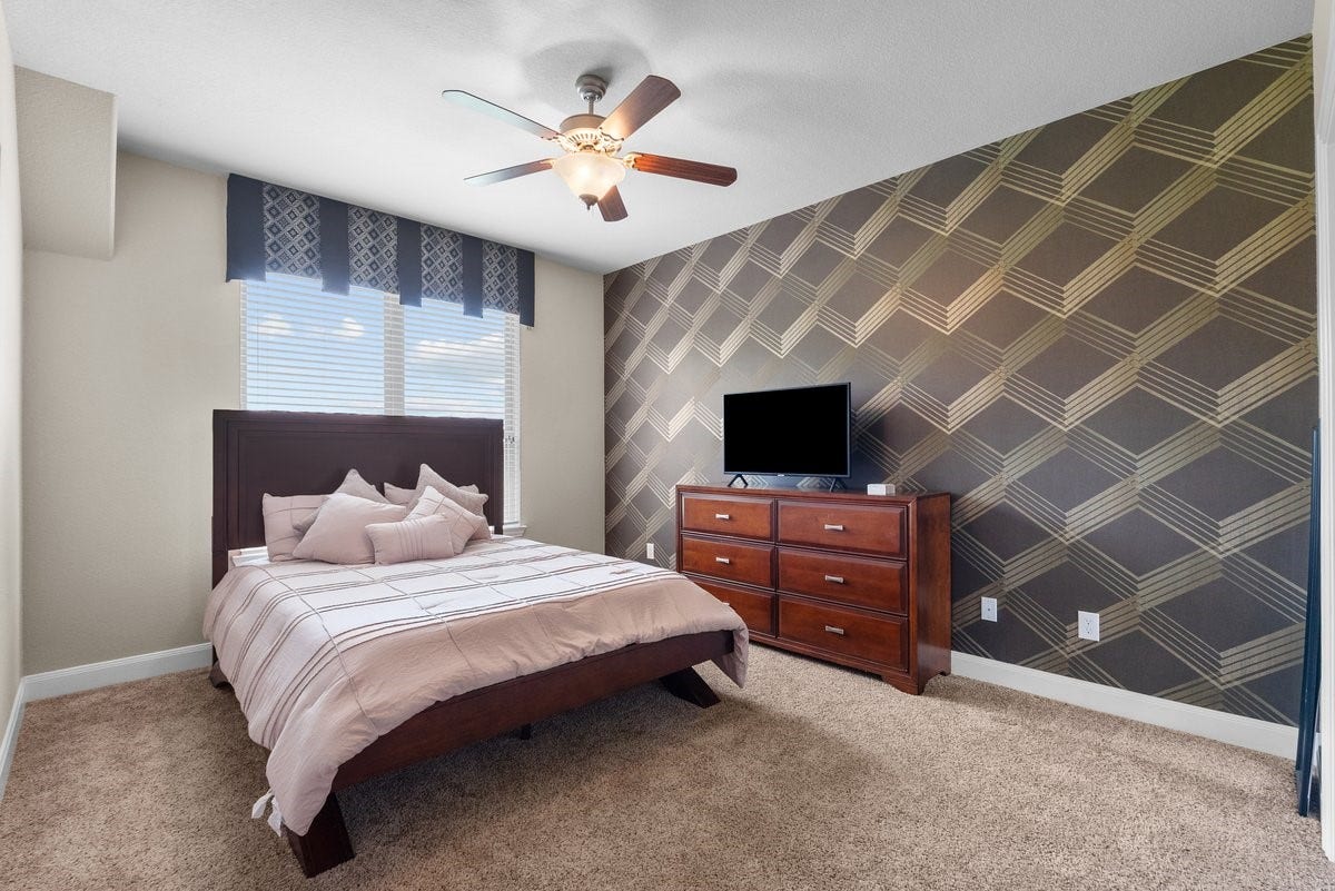 416 Via Regatta Drive, Webster, TX 77598 This spacious second-floor secondary bedroom is a true showstopper, featuring an incredible, custom geometric accent wall.