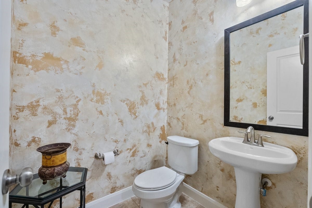 416 Via Regatta Drive, Webster, TX 77598 Just steps away, the first-floor powder room makes a striking impression, featuring gorgeous, custom hand-painted walls by a professional artisan and elegant tile flooring. Exquisite, custom hand-painted walls by a professional artisan in the first-floor half bath