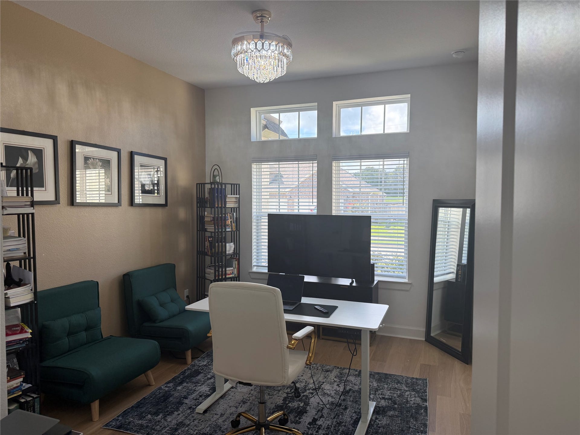 9911 Deep Water Drive, Missouri City, TX 77459 Utilize this 4th bedroom as an inviting office space with large windows, elegant chandelier, and stylish decor, perfect for productivity and comfort.