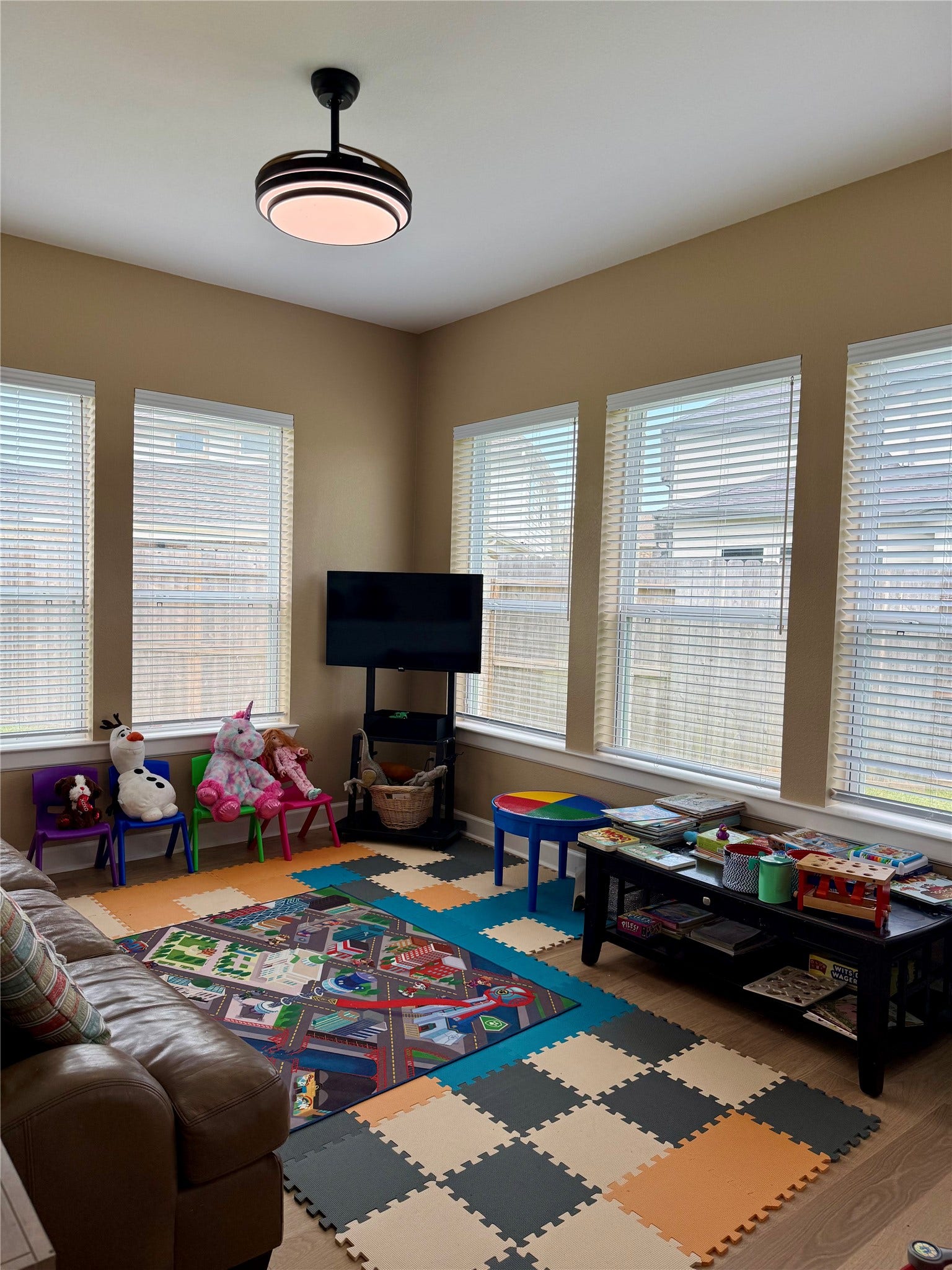9911 Deep Water Drive, Missouri City, TX 77459 Retreat area utilized as a Bright and inviting playroom featuring large windows, colorful foam flooring, and ample space for toys and activities.