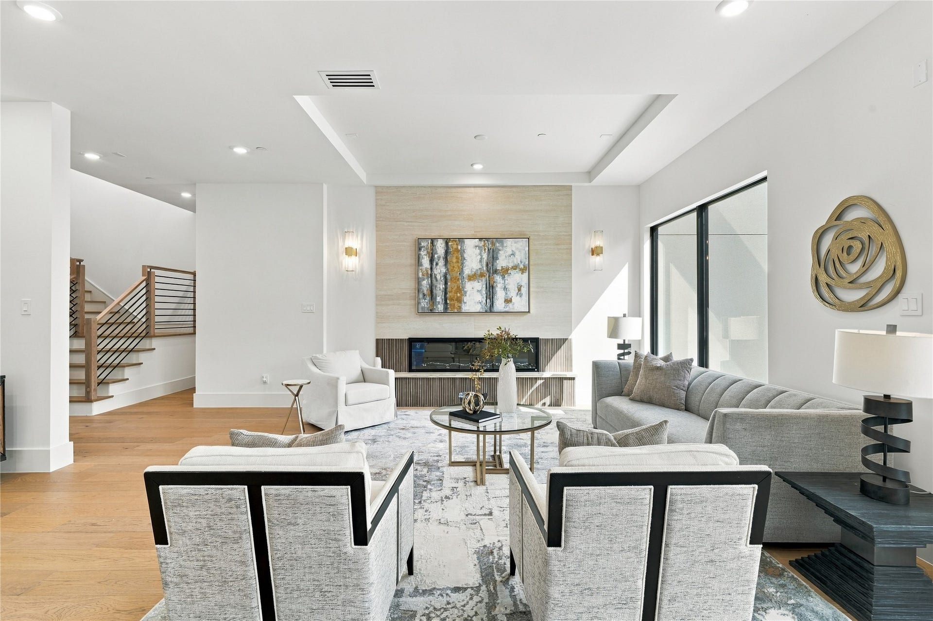 Inviting living space featuring an open layout, contemporary finishes, and expansive windows.