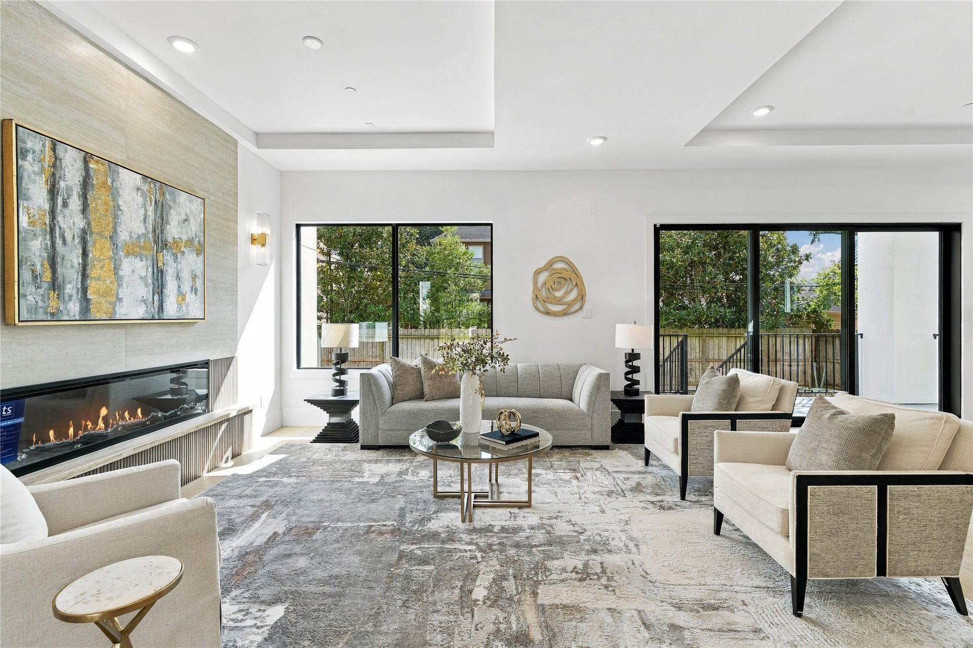 Open-concept living area featuring expansive windows, contemporary furnishings, and seamless indoor-outdoor views.