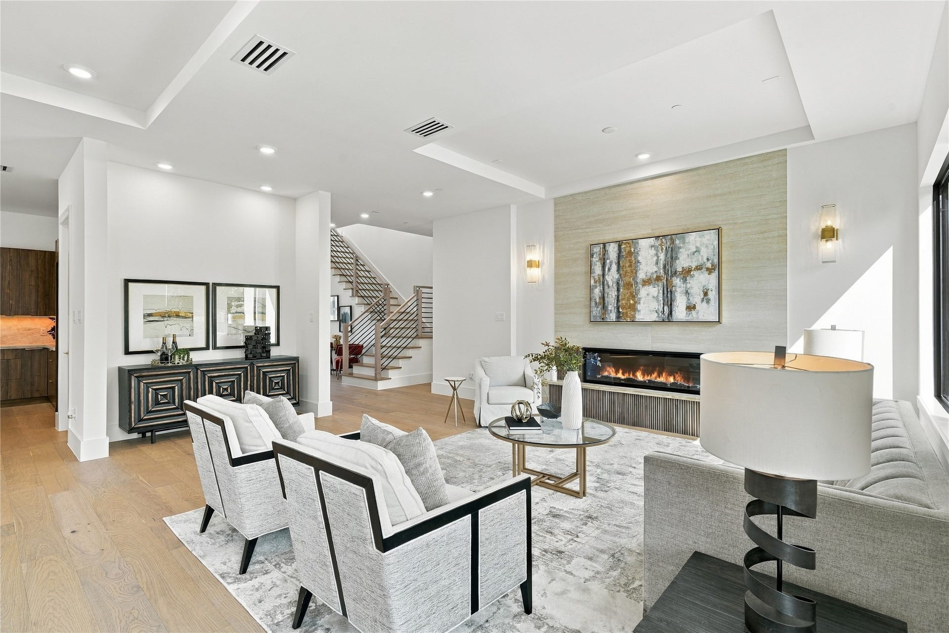 Elegant living room featuring neutral tones, modern furnishings, and abundant natural light.