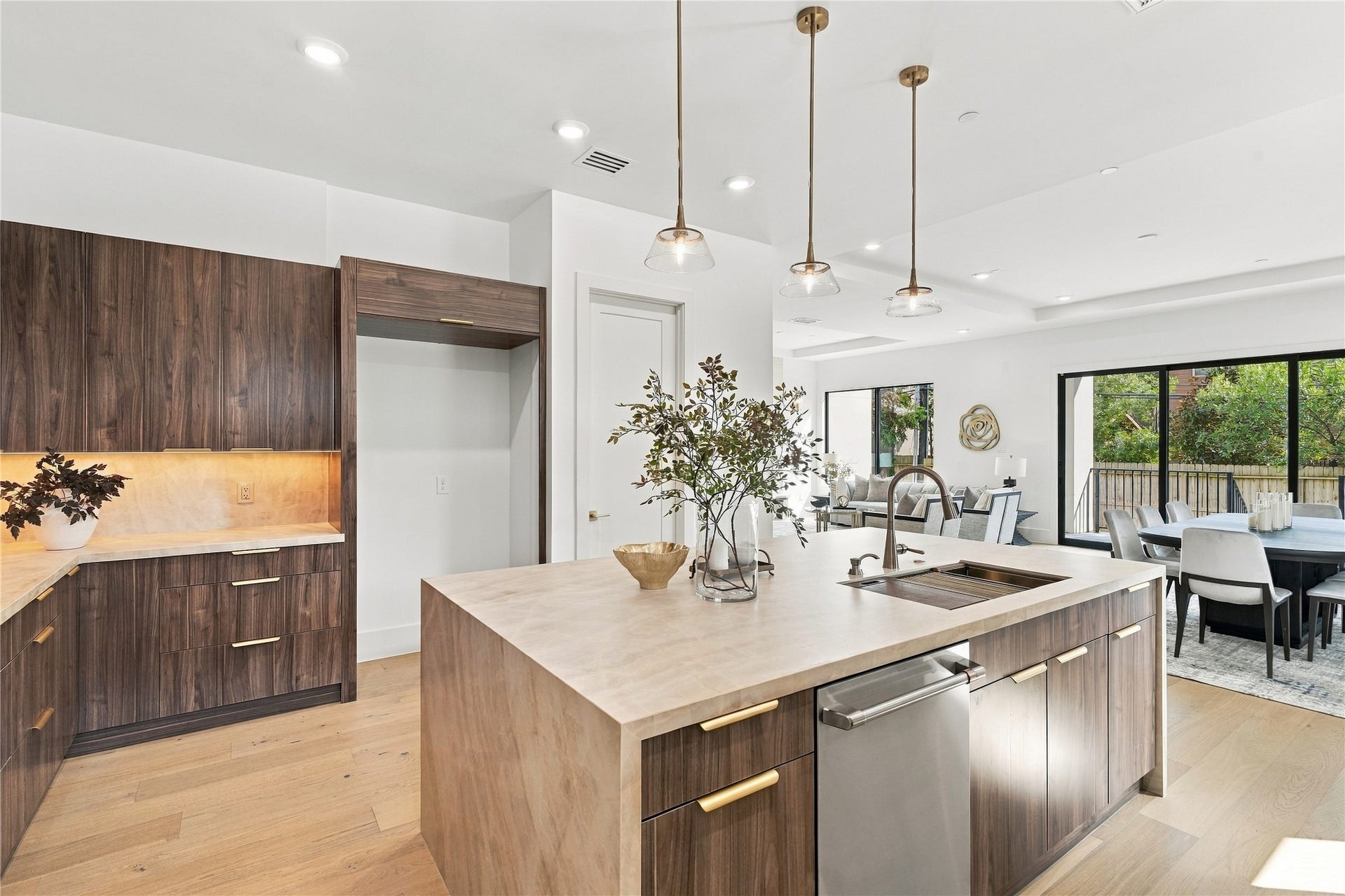Spacious open-concept living and dining area with sophisticated finishes and a bright, airy atmosphere.