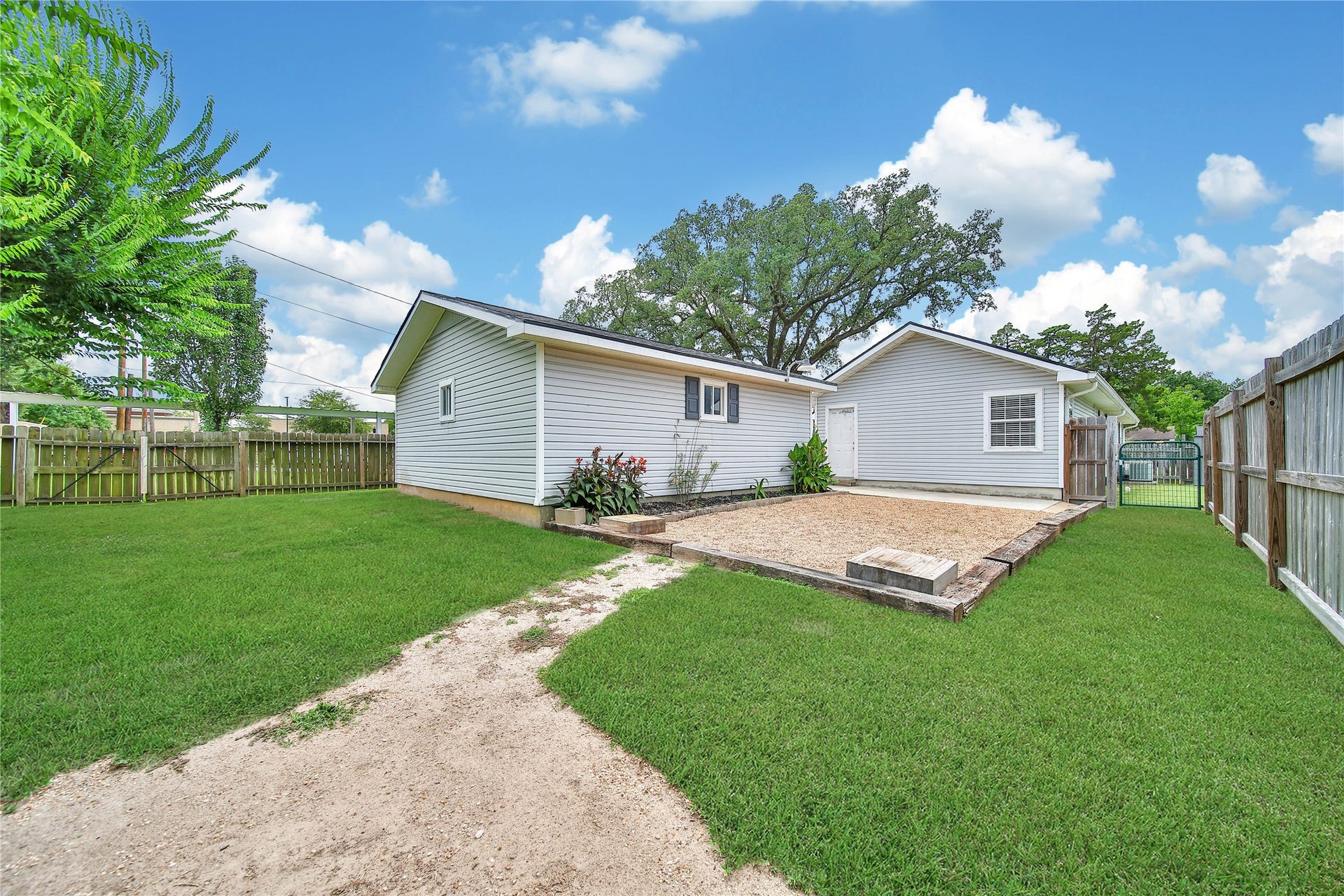 307 Lawrence Street, Tomball, TX 77375 A second view of the back yard shows all of the room located behind the garage.