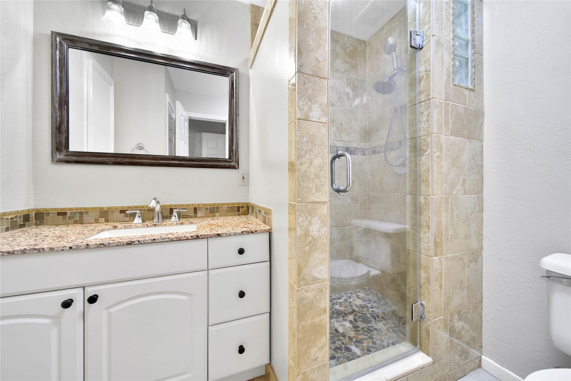 307 Lawrence Street, Tomball, TX 77375 Primary ensuite bath has a walk-in shower & great storage not seen in the photo.